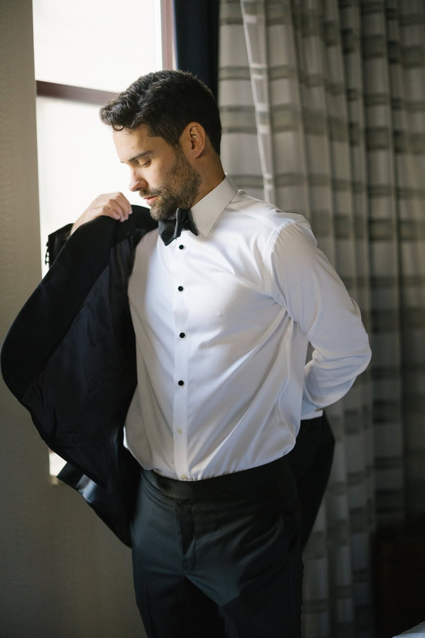 Groom bowtie preparation Notary Hotel wedding