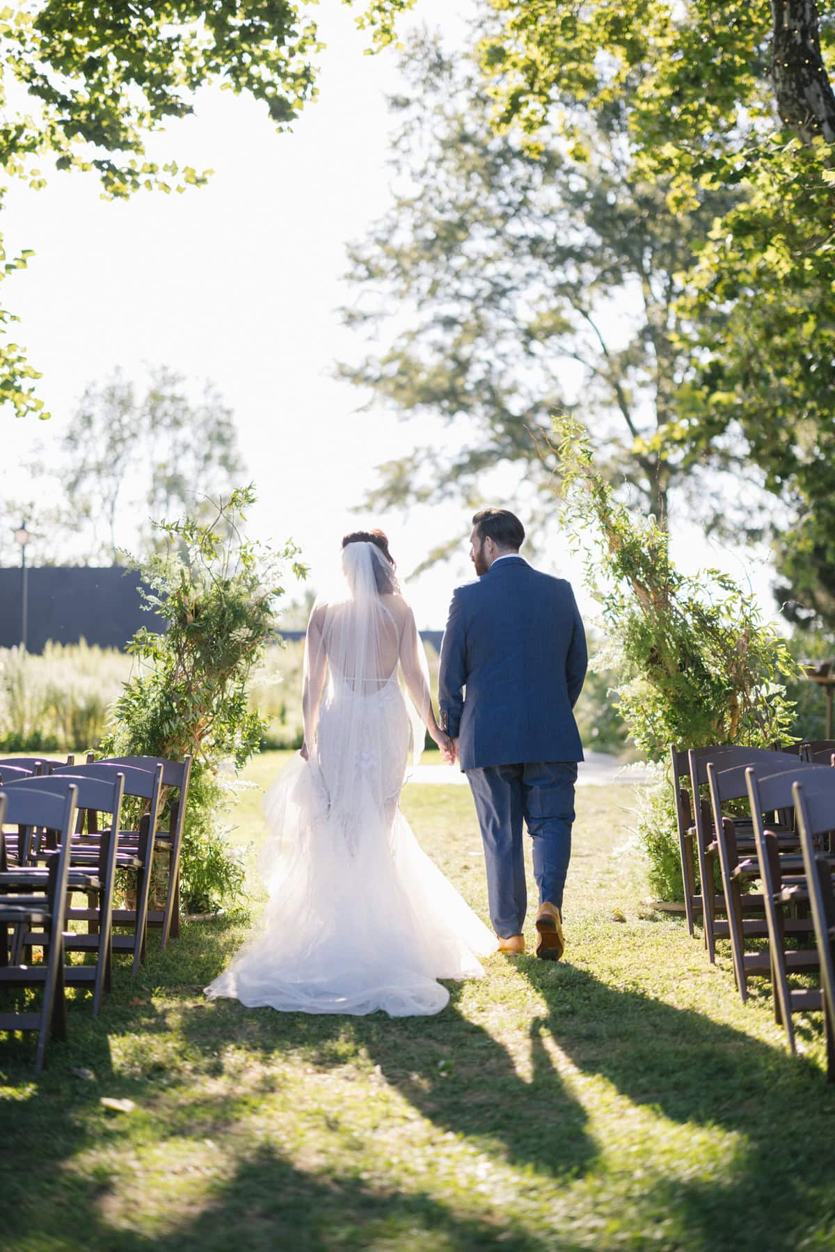 Bishop Farmstead Wedding bride and groom walking into sunset