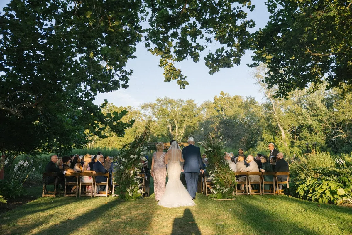 bishop farmstead wedding bride walking down aisle ceremony