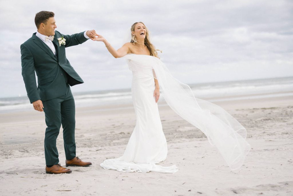 Couple portrait on the private beach at ICONA Avalon with ocean backdrop in Avalon NJ