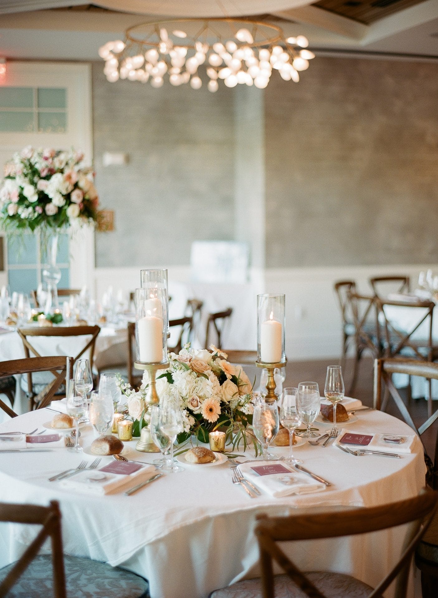 Elegant reception table with florals and chandelier at River House at Odette's in New Hope PA