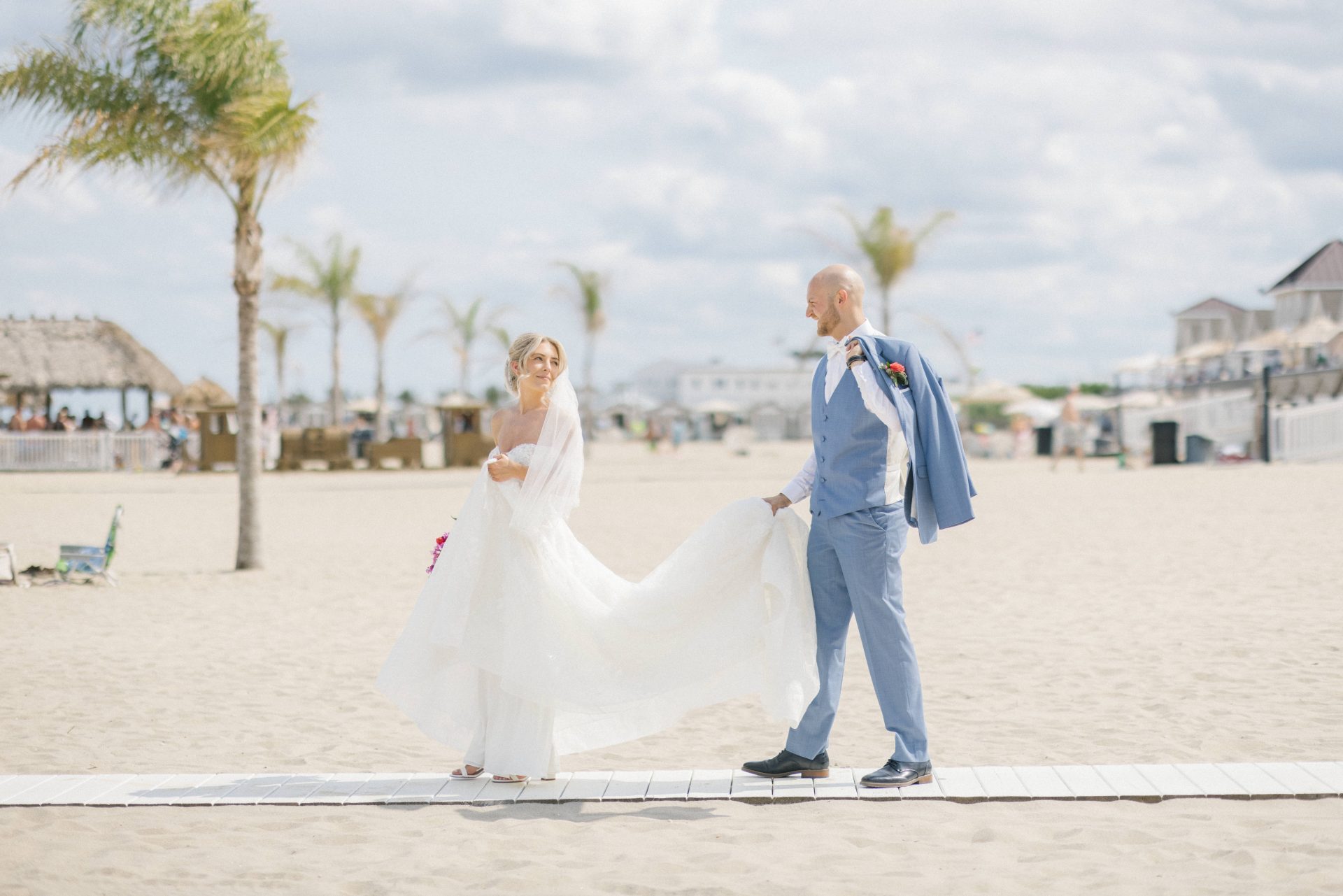 Couple walking on the boardwalk at Windows on the Water wedding, Sea Bright NJ