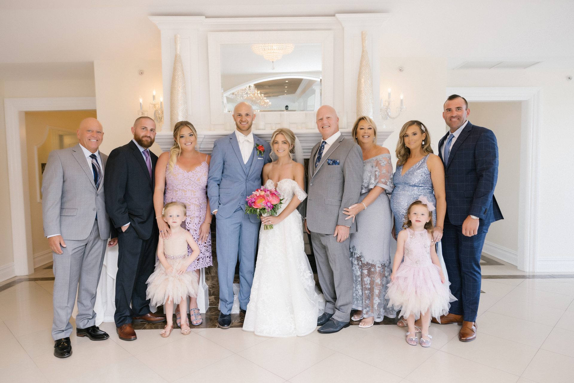 Wedding family formal portrait by the fireplace with flower girls in the Empress Ballroom at Windows on the Water, Sea Bright NJ
