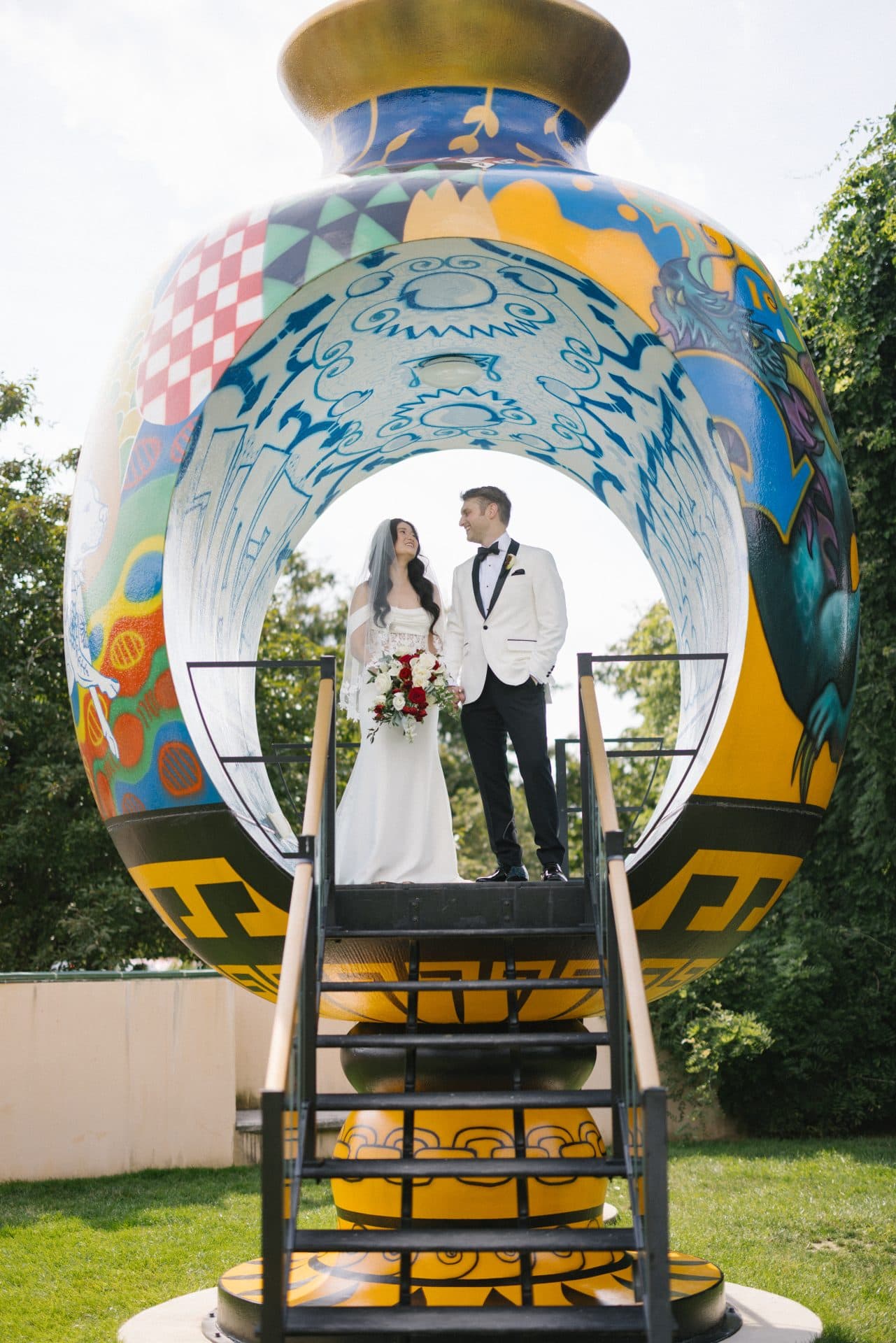 Couple inside the painted vase at Put Yourself in the Picture sculpture at Grounds for Sculpture, Hamilton NJ