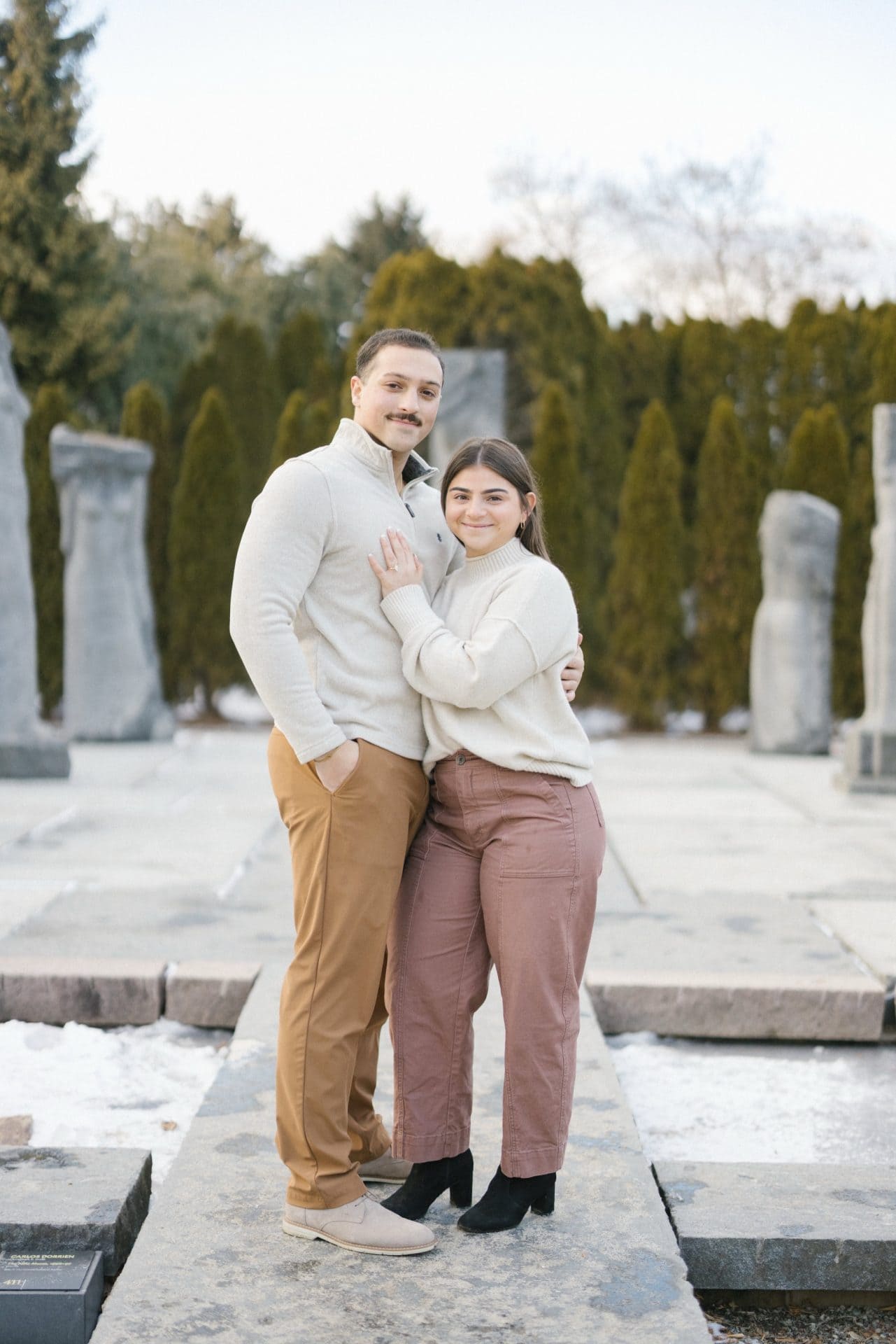 Winter engagement portraits at Grounds for Sculpture Nine Muses Hamilton NJ - couple smiling at camera after snow proposal