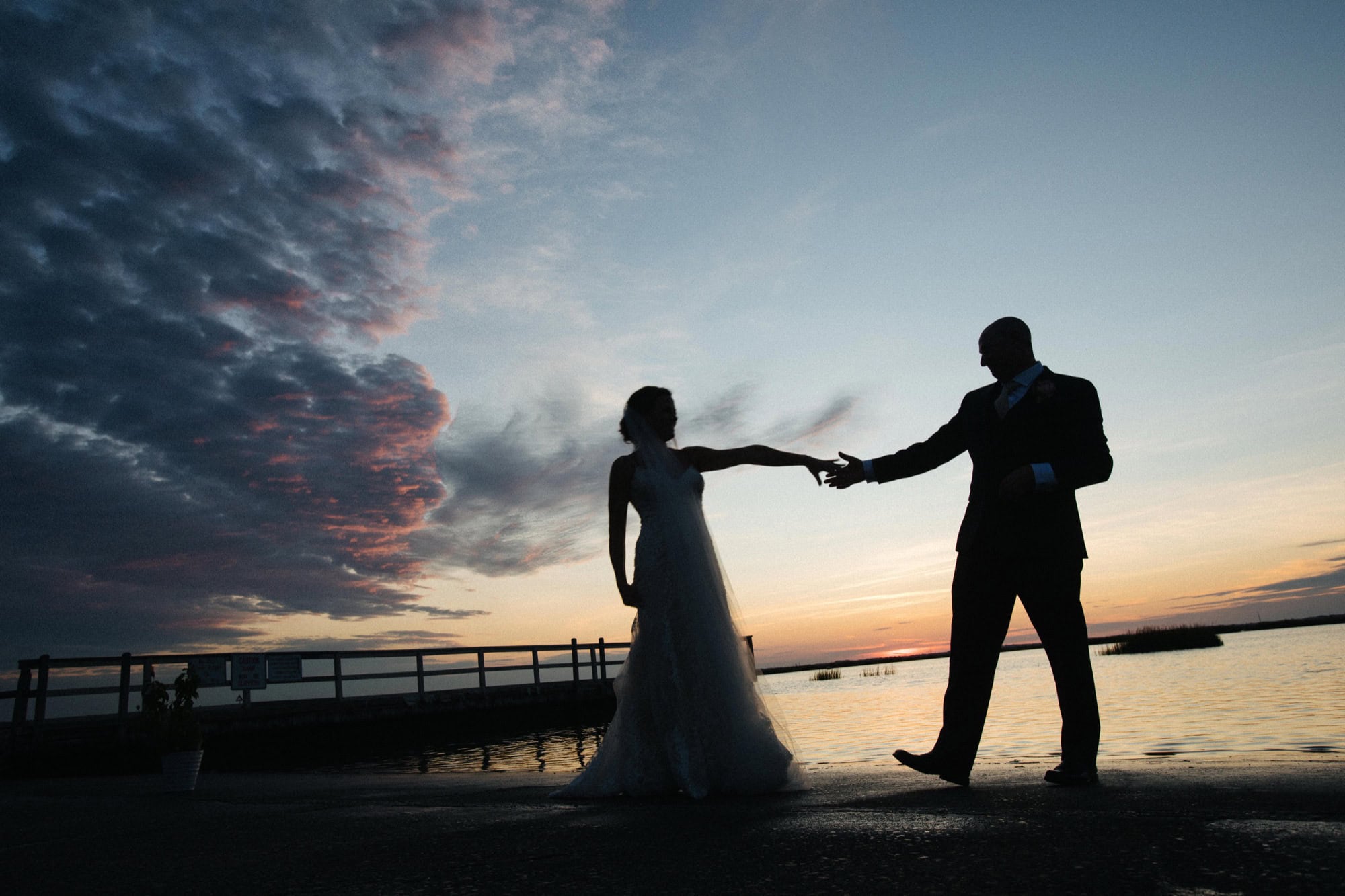 Couple silhouette at sunset at ICONA Avalon in Avalon NJ