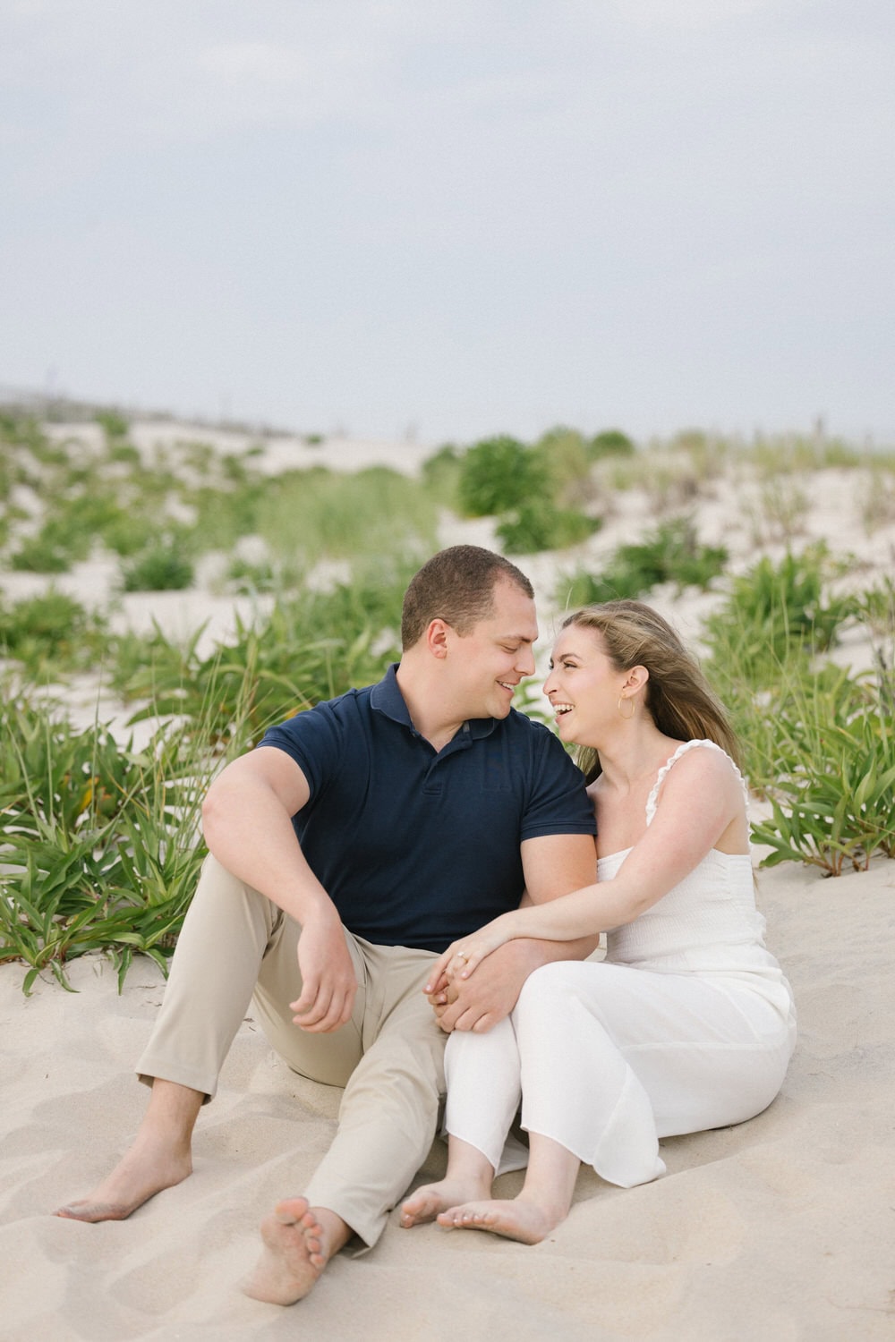 LBI proposal photography - couple hugging after engagement on beach
