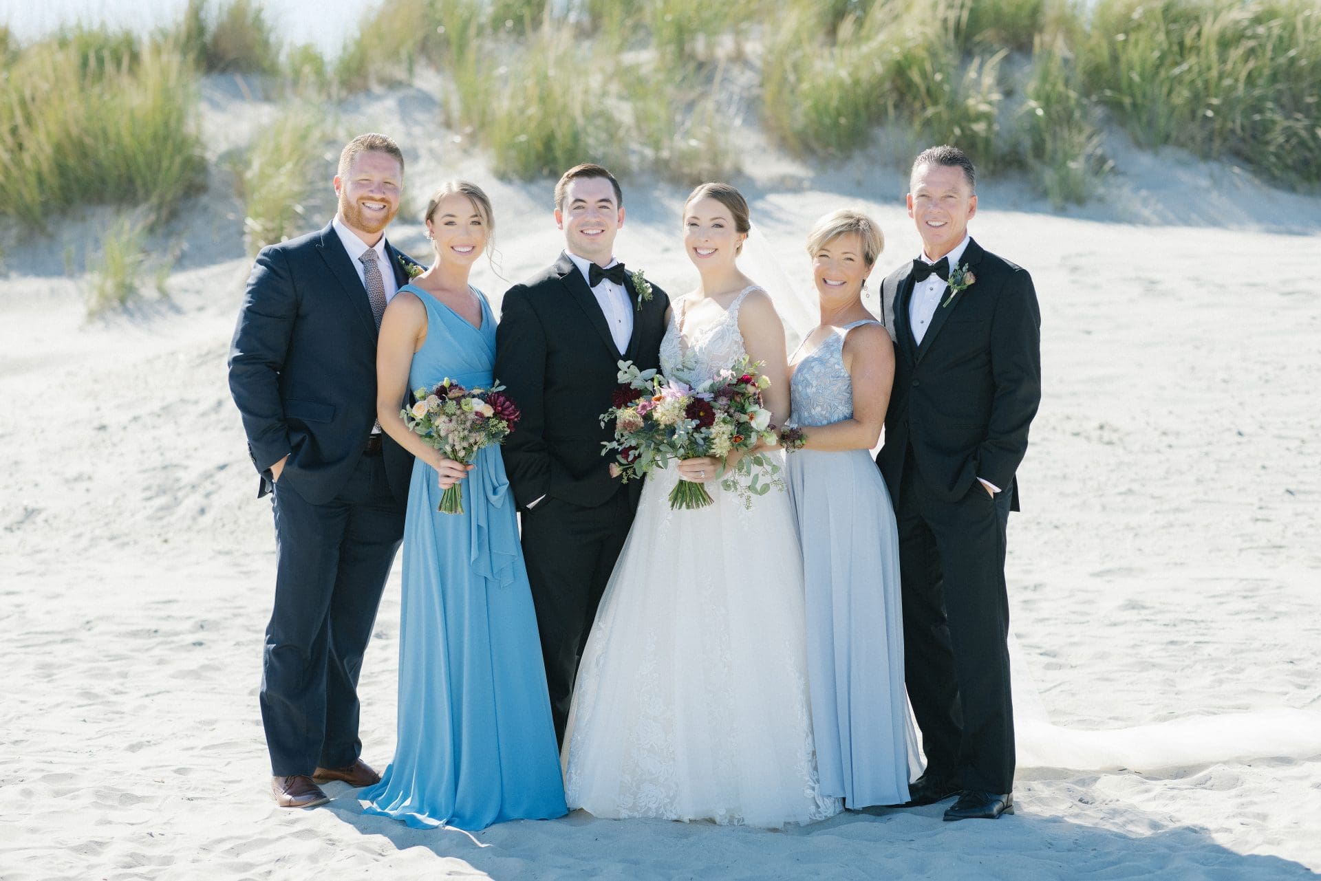 Extended family portrait on the beach facing the ocean at ICONA Avalon in Avalon NJ