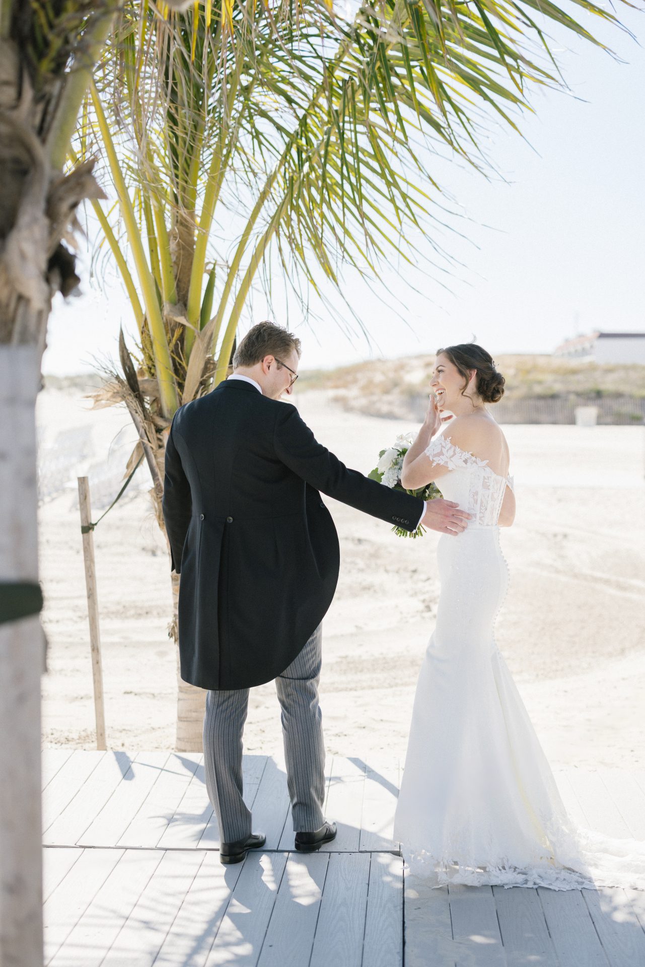 First look moment under palm tree at ICONA Diamond Beach in Wildwood NJ