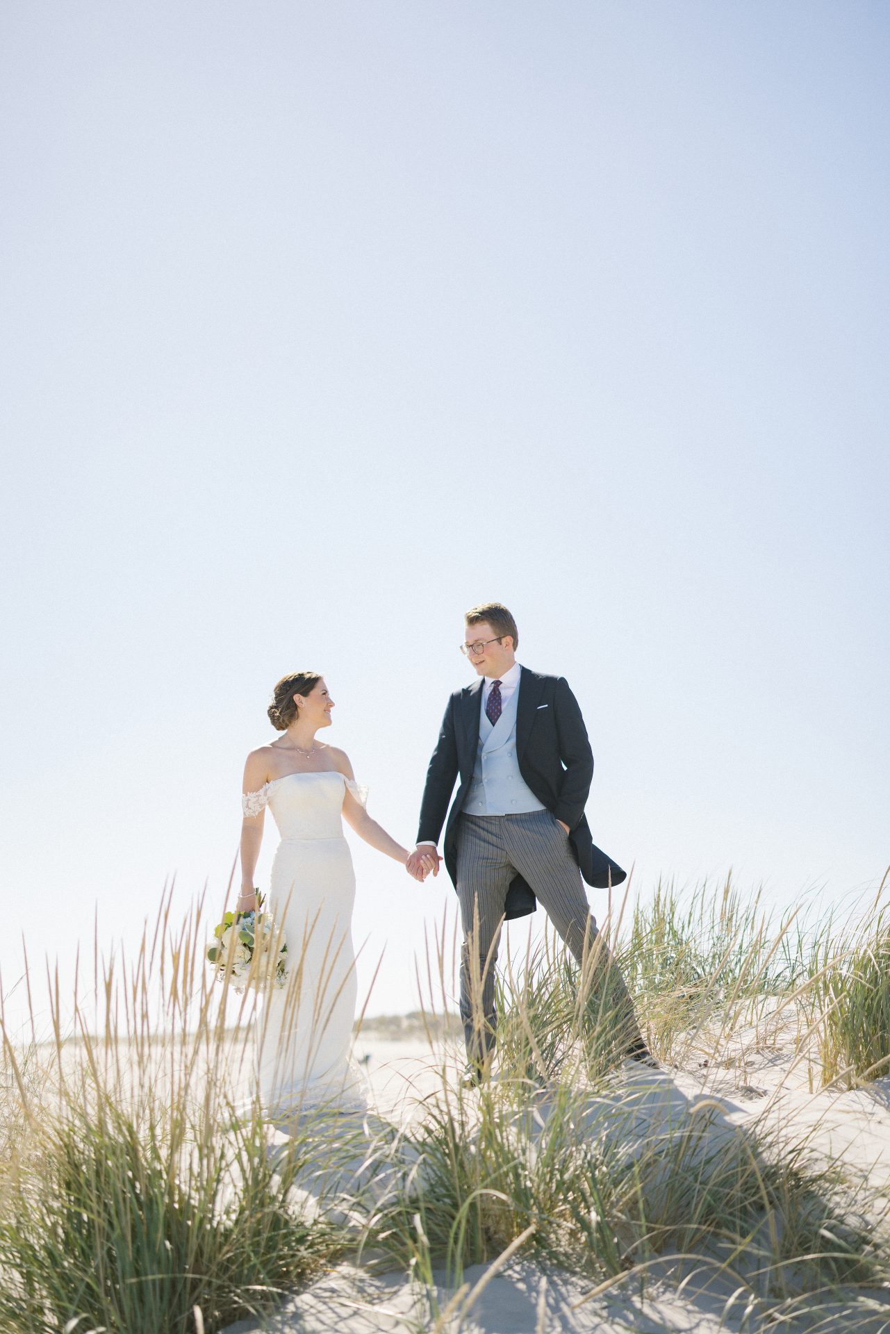 Couple portrait in beach grass dunes at ICONA Diamond Beach Wildwood NJ