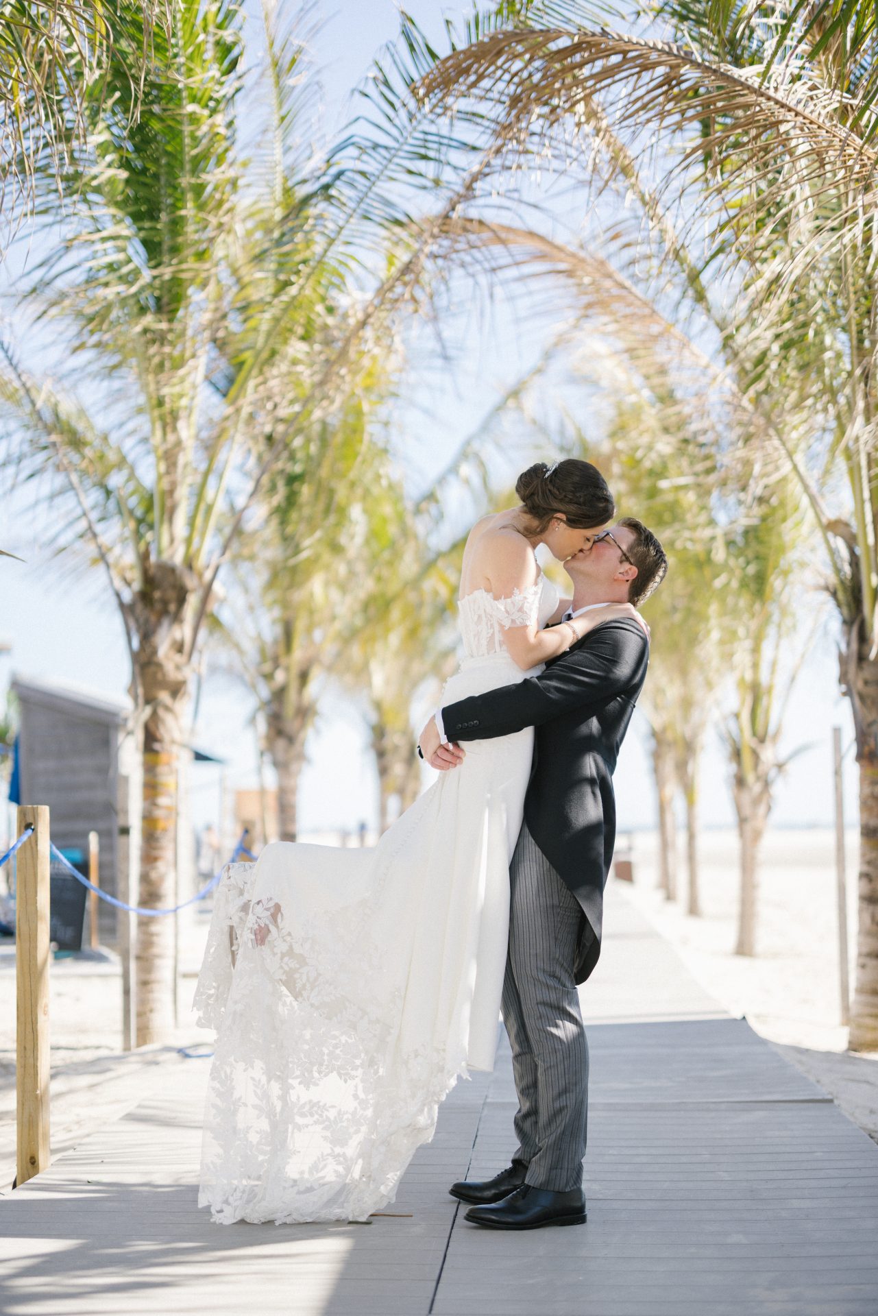 Couple between palm trees on the walkway at ICONA Diamond Beach Wildwood NJ