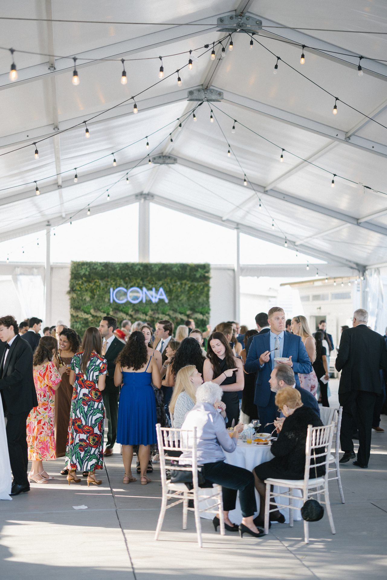 Guests enjoying cocktail hour in the beach tent at ICONA Diamond Beach Wildwood NJ