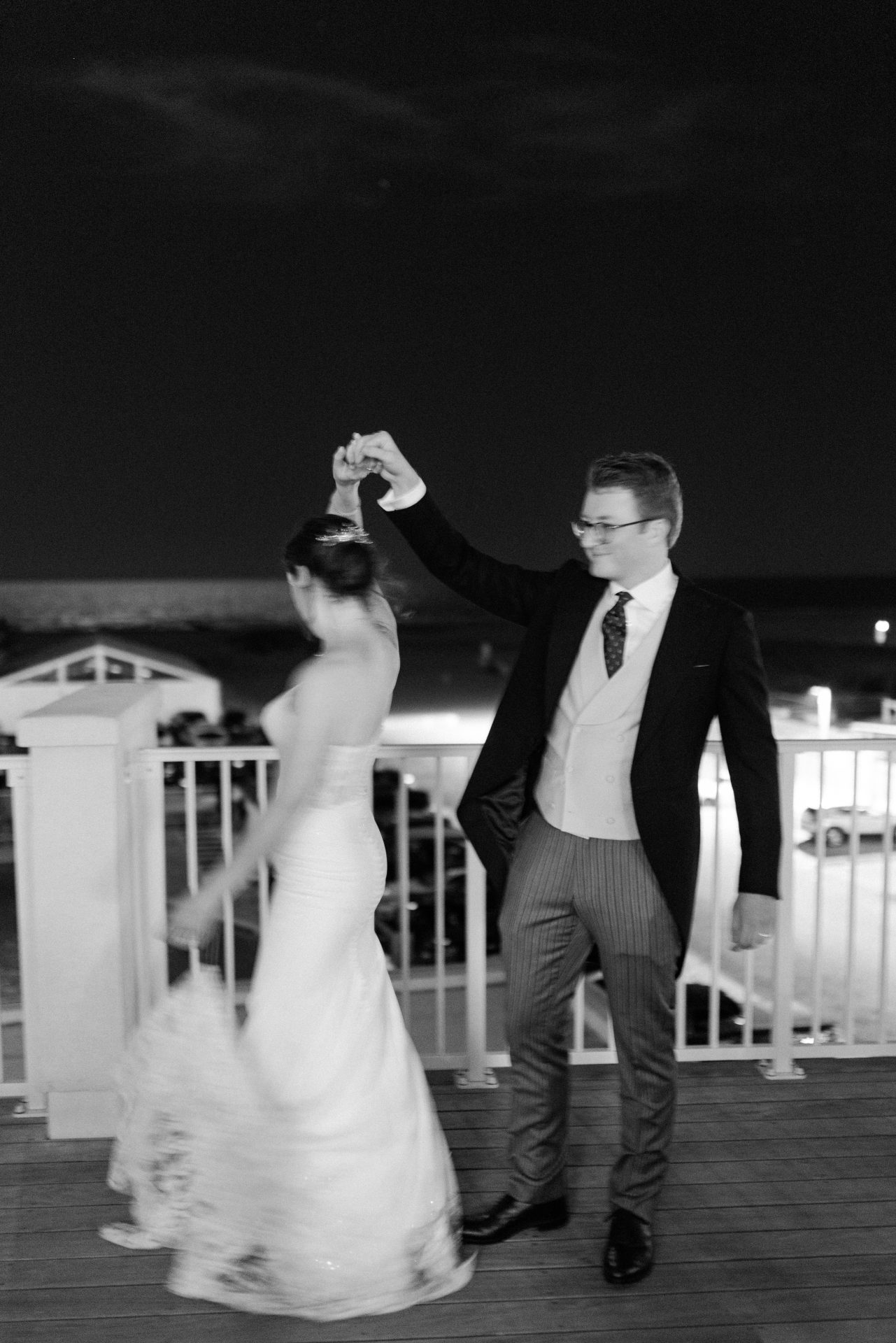 Couple spinning and dancing on the balcony at night at ICONA Diamond Beach Wildwood NJ