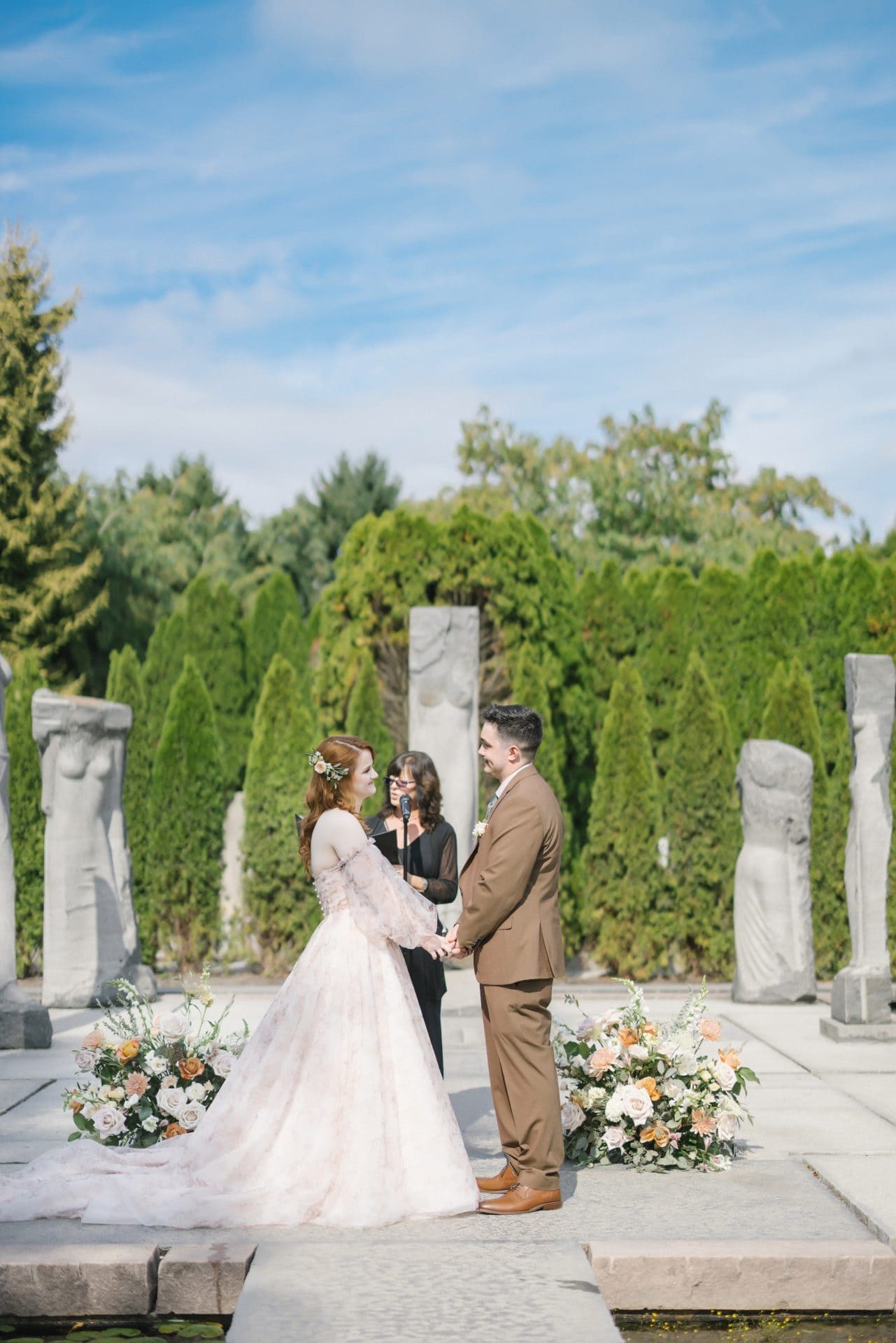 Outdoor wedding ceremony at Nine Muses with sculptures at Grounds for Sculpture Hamilton NJ