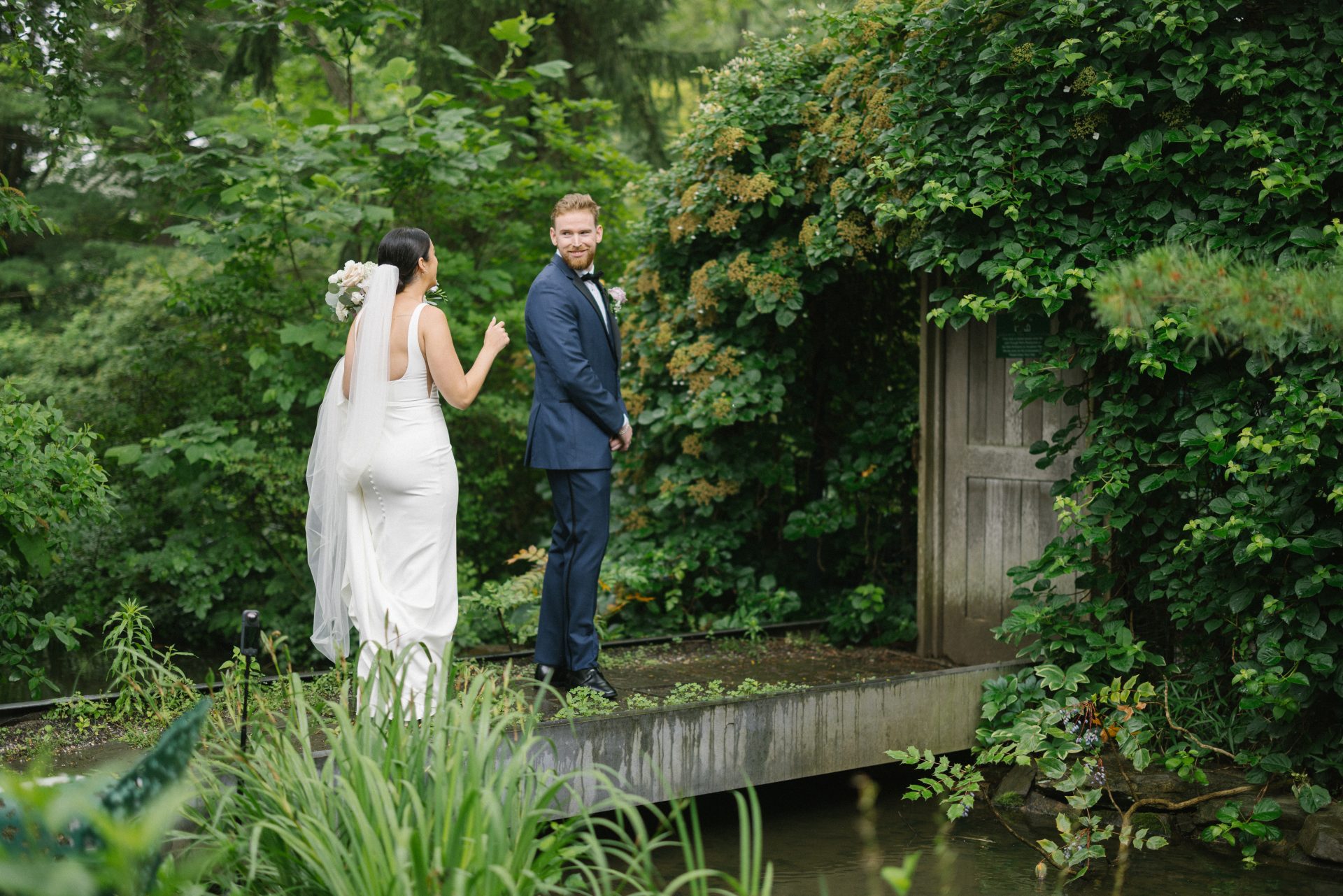 Couple first look at The Causeway with ivy-covered barn doors at Grounds for Sculpture in Hamilton NJ