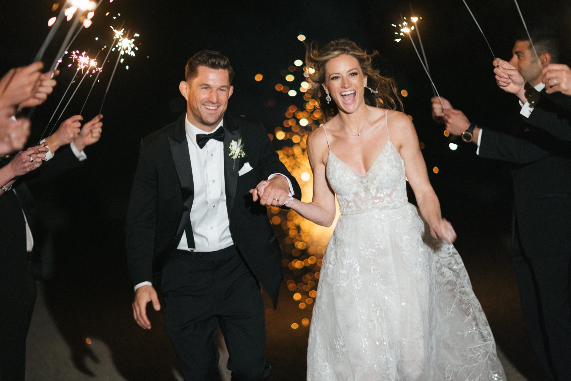Couple running through sparkler exit at River House at Odette's wedding in New Hope PA