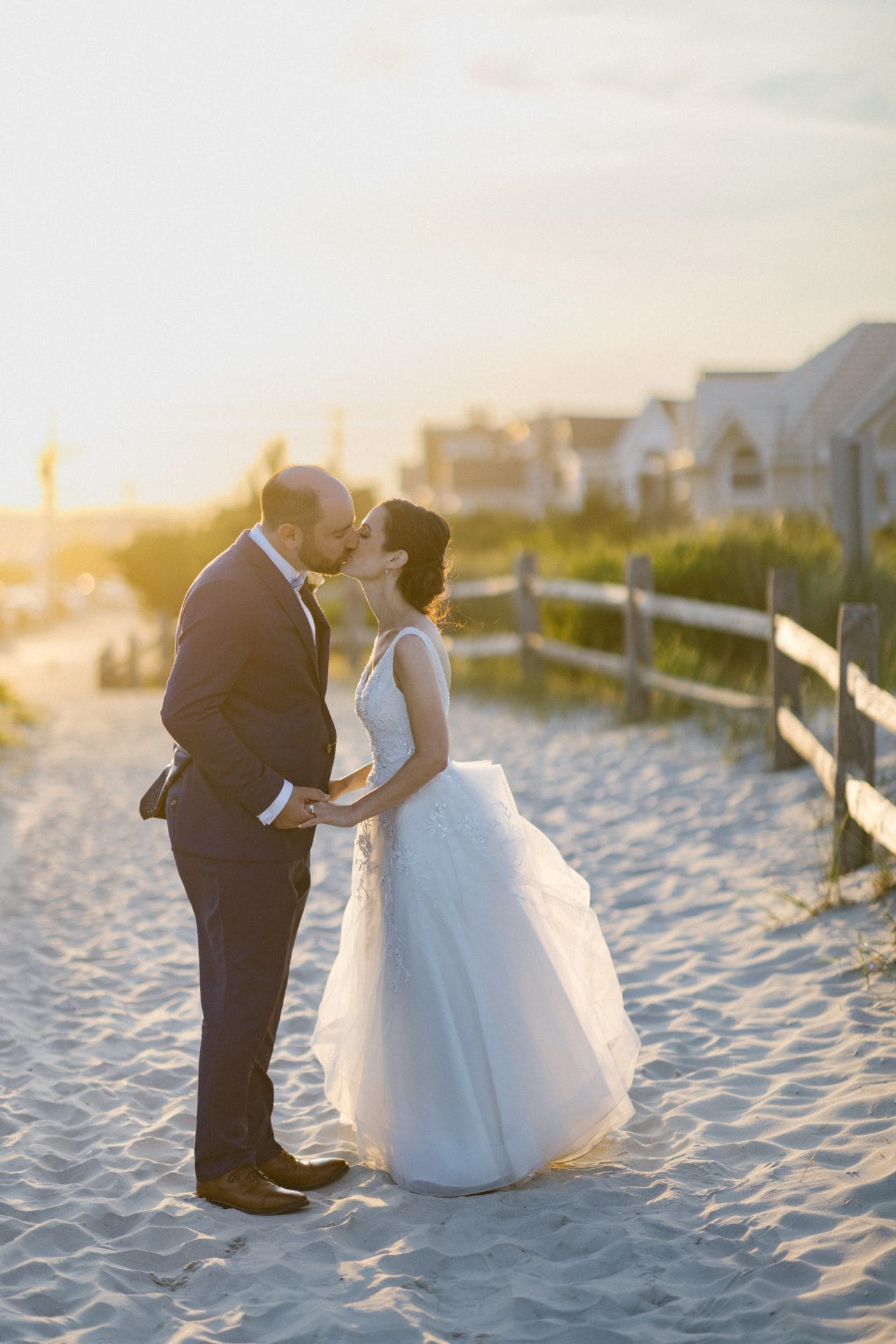 Couple golden hour portrait on the sand dunes at ICONA Avalon in Avalon NJ