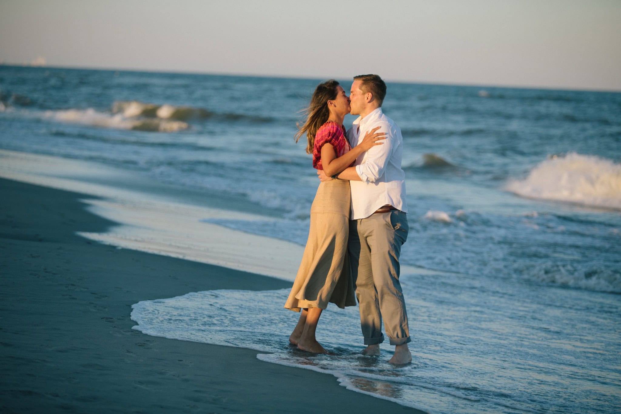 Dogs joining surprise proposal celebration on Sea Isle City beach at golden hour