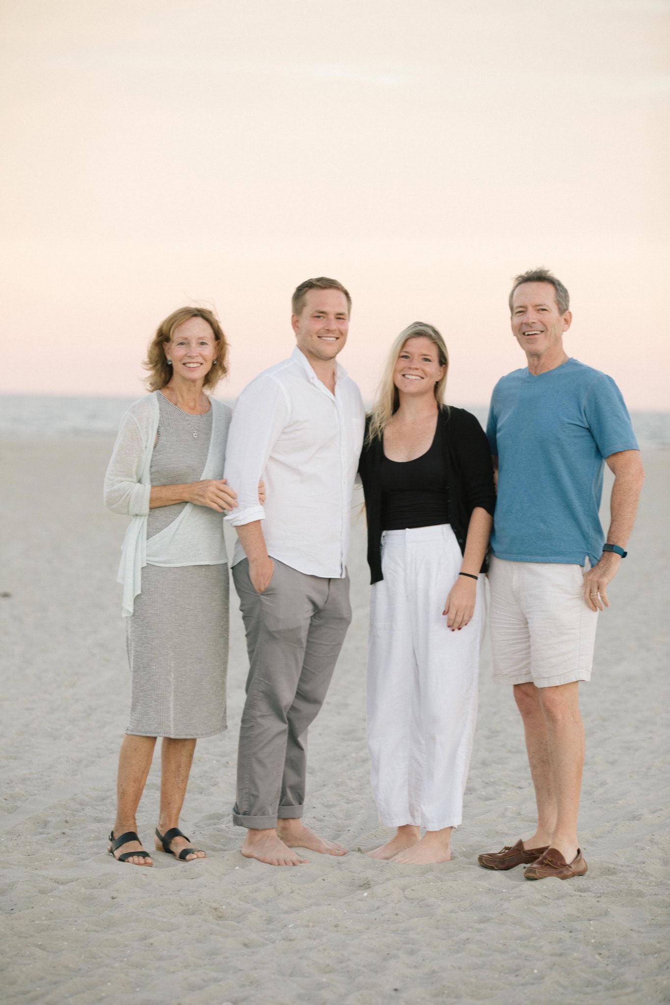 Sea Isle City engagement portrait with dramatic purple and pink sunset sky over the Jersey Shore
