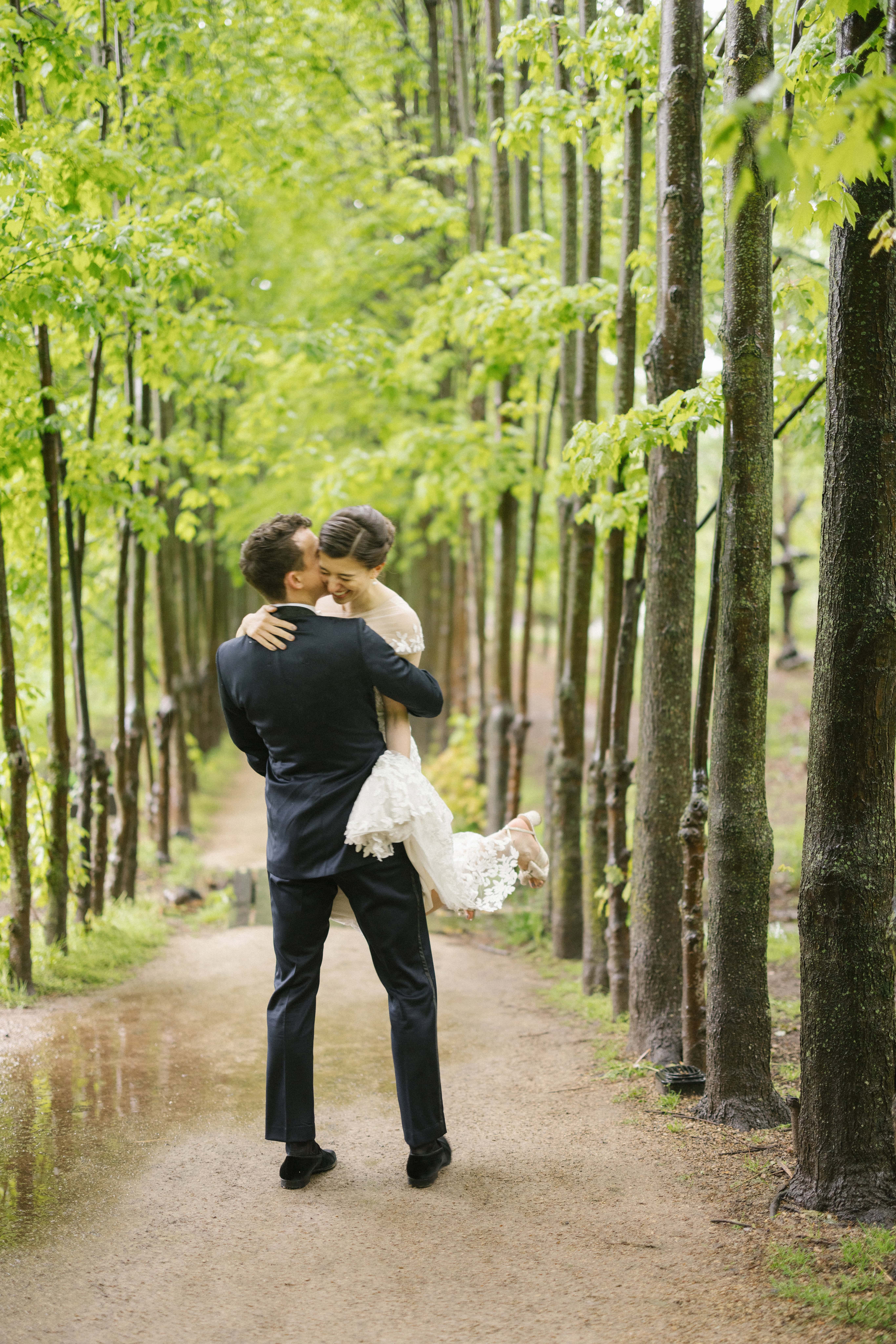 Bride and groom together on a tree-lined path at Grounds for Sculpture, Hamilton NJ