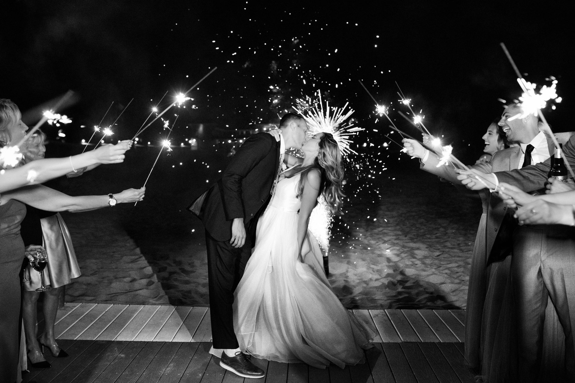 Bride and groom sparkler exit kiss on the beach at Windows on the Water wedding, Sea Bright NJ, black and white