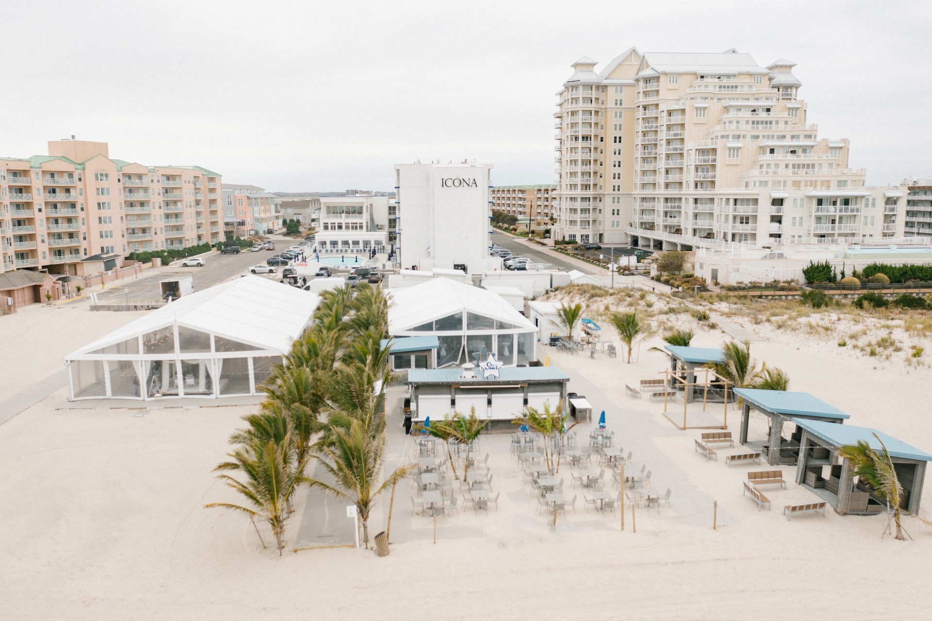 Aerial overview of ICONA Diamond Beach with hotel beach tents and palm walkway in Wildwood NJ