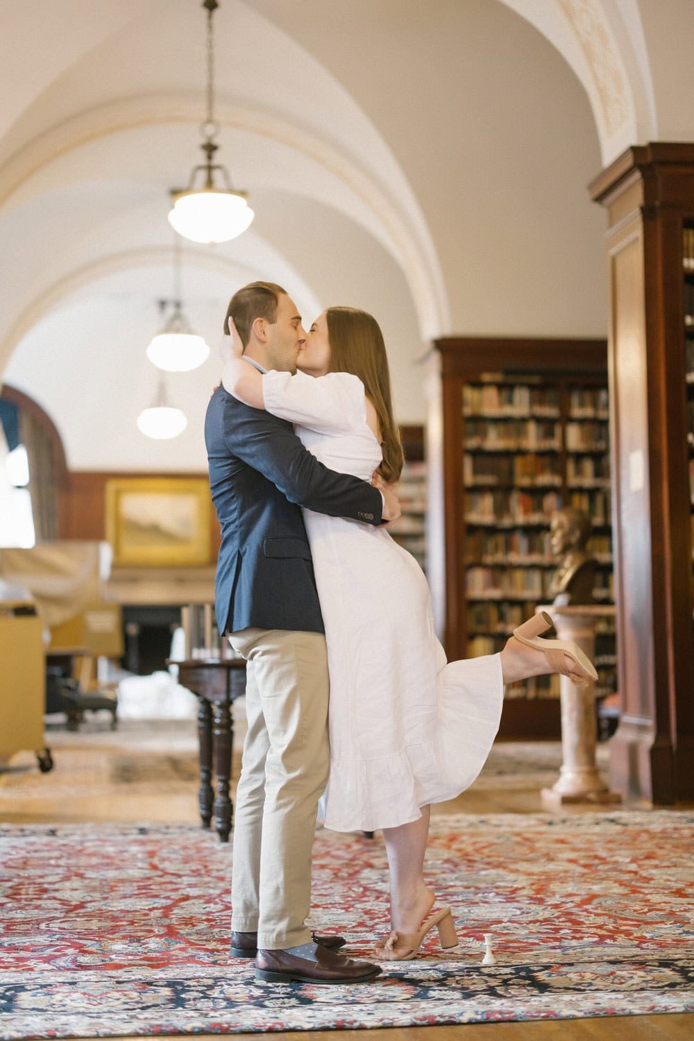 Union League Philadelphia - couple kissing after proposal in library