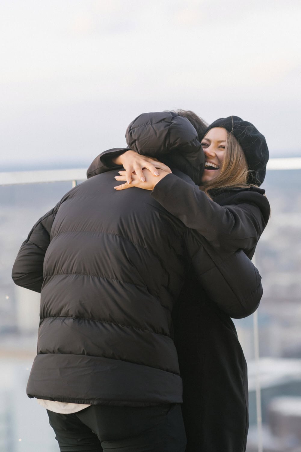 Matt Wolff and Kim Lloyd hugging after the surprise proposal on the W Hotel Philadelphia rooftop