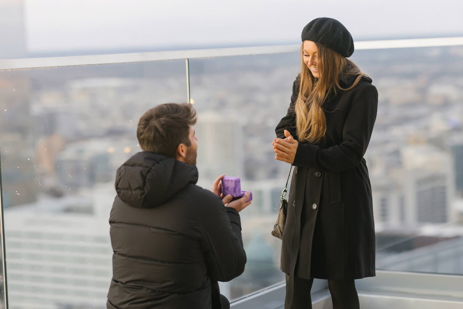 Matt Wolff and Kim Lloyd smiling with the Philadelphia skyline after their W Hotel rooftop proposal