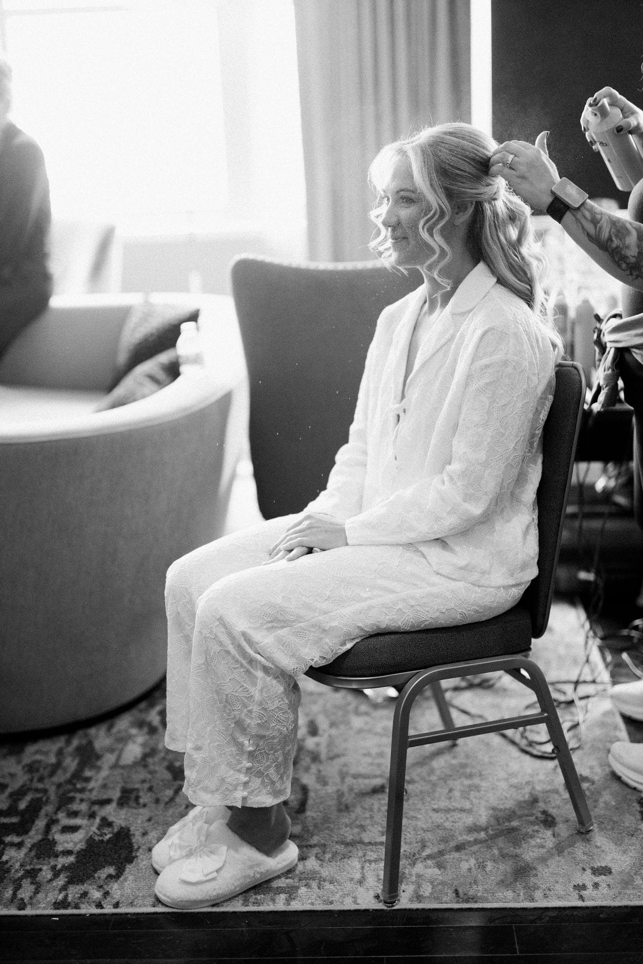 Bride getting hair done in white pajamas at President Suite Loews Hotel Philadelphia