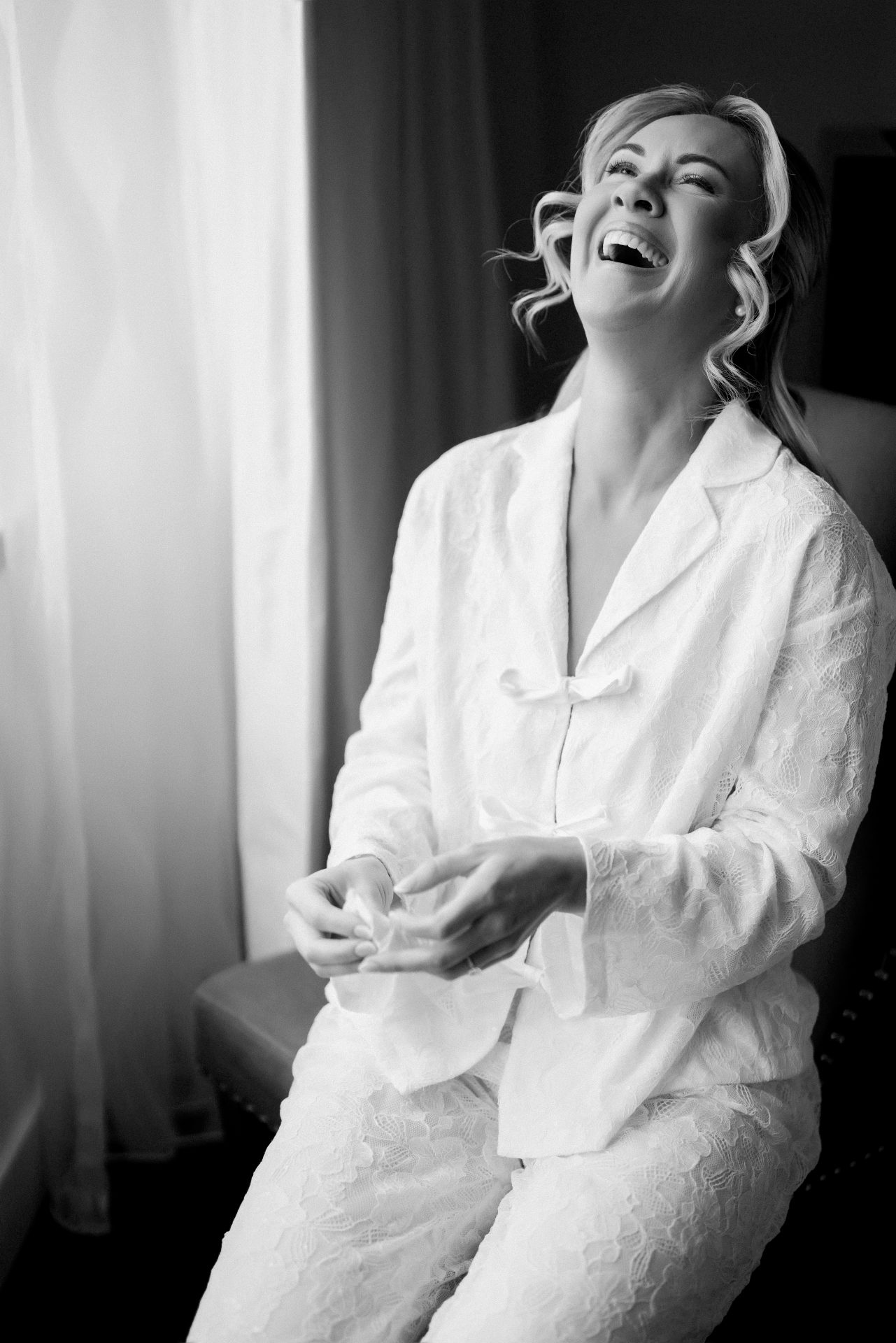 Emotional bride laughing and crying after reading grooms letter at Loews Hotel