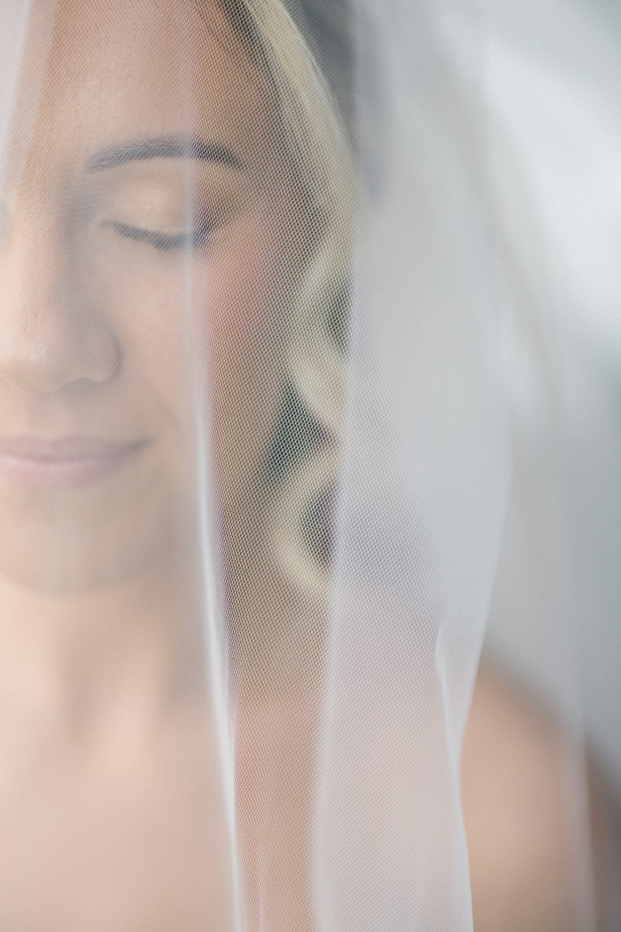 Close up bridal portrait behind veil soft light Philadelphia wedding