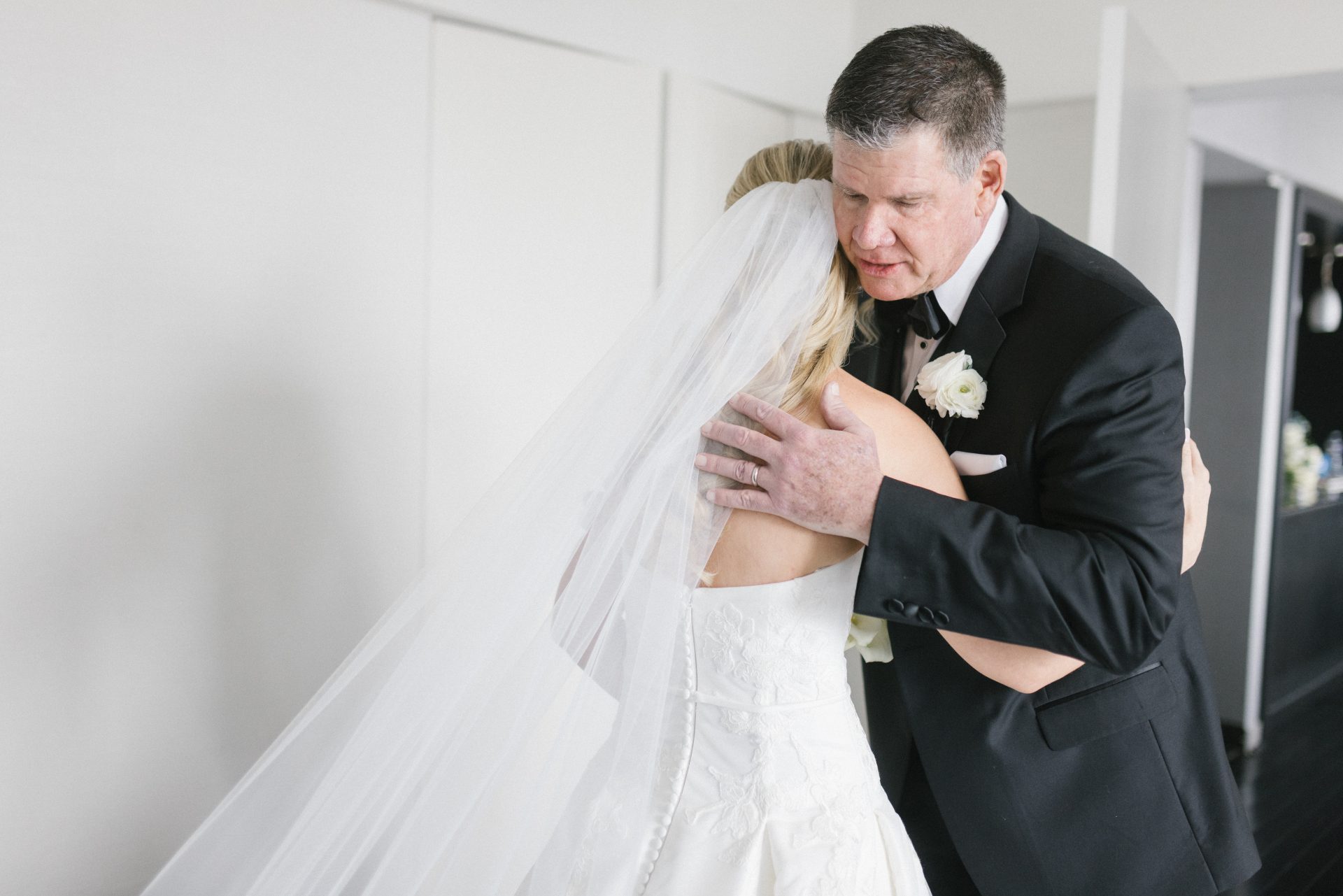 Father and bride emotional embrace during first look at Loews Hotel Philadelphia