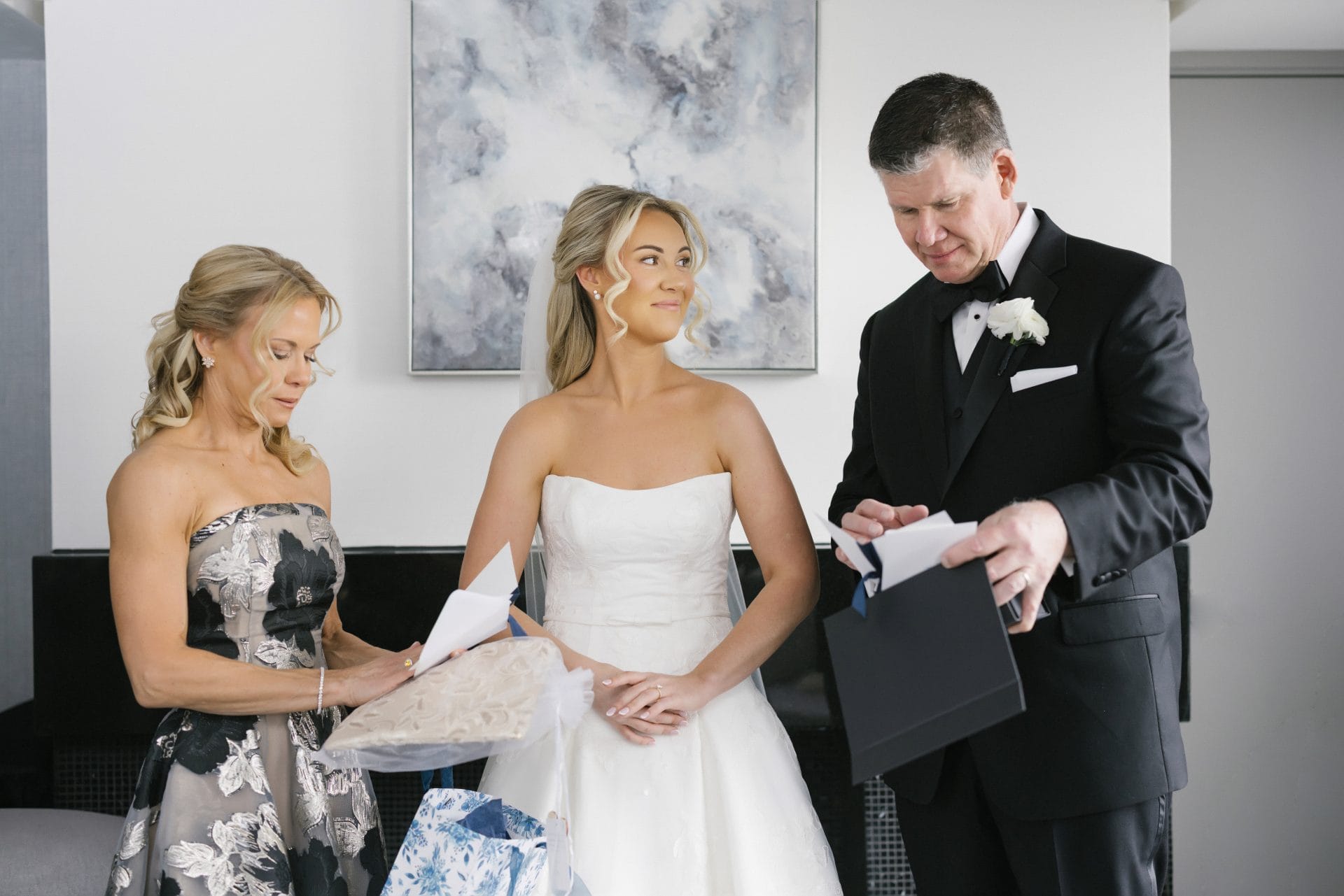 Bride and parents opening gifts together on wedding morning Philadelphia