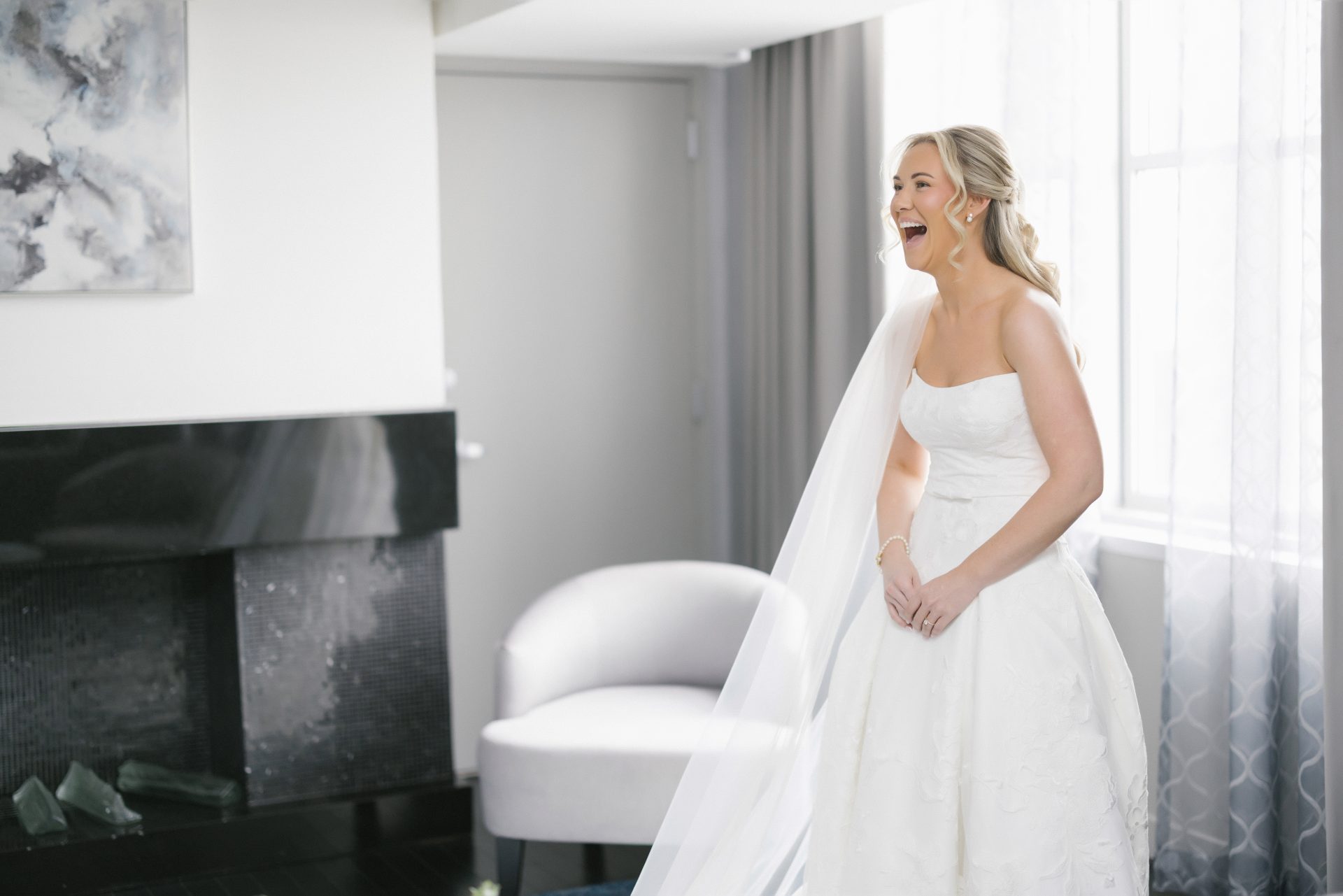 Bride laughing in hotel suite before Ballroom at the Ben wedding ceremony