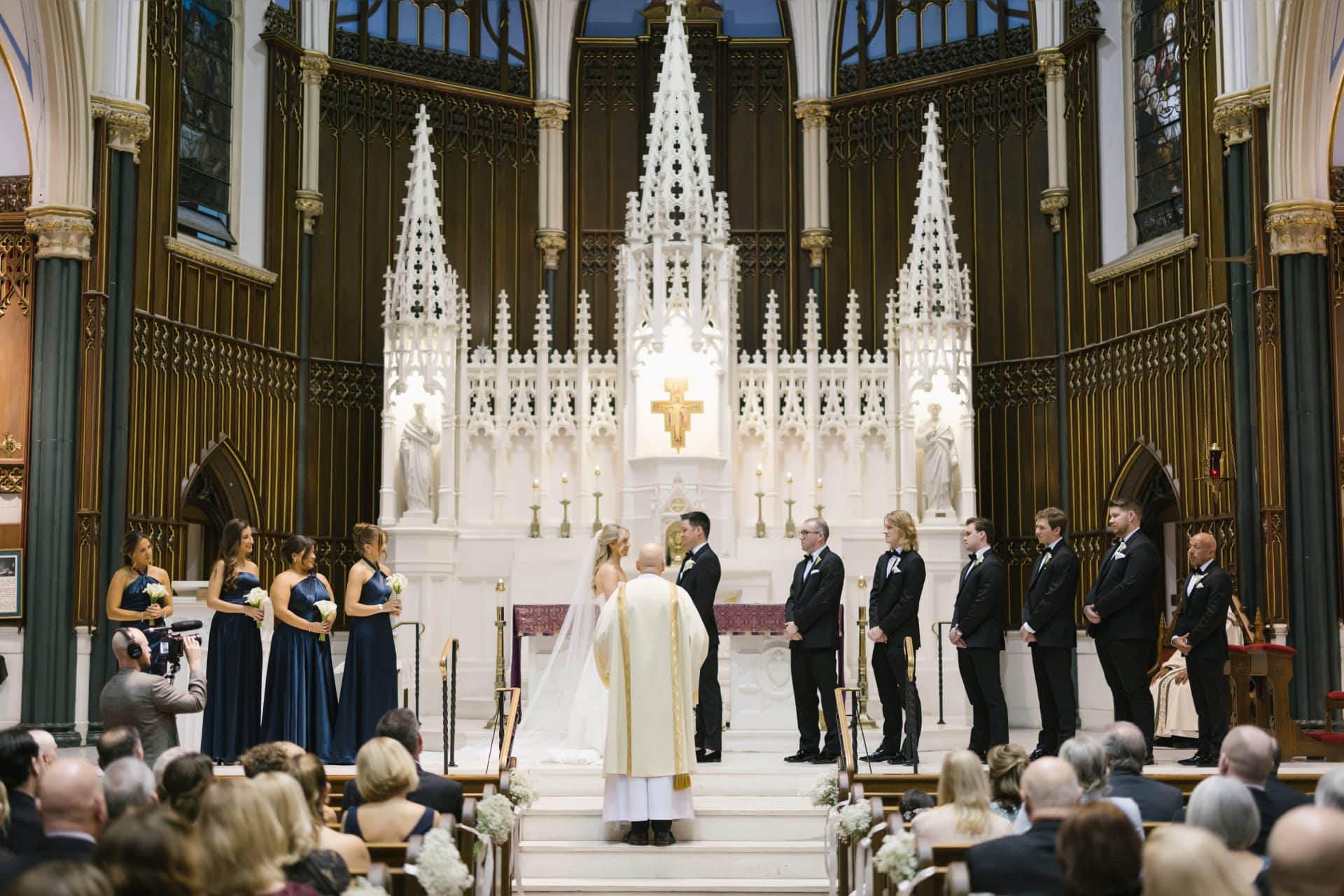Wide shot wedding ceremony at altar with wedding party at St John the Evangelist Philadelphia