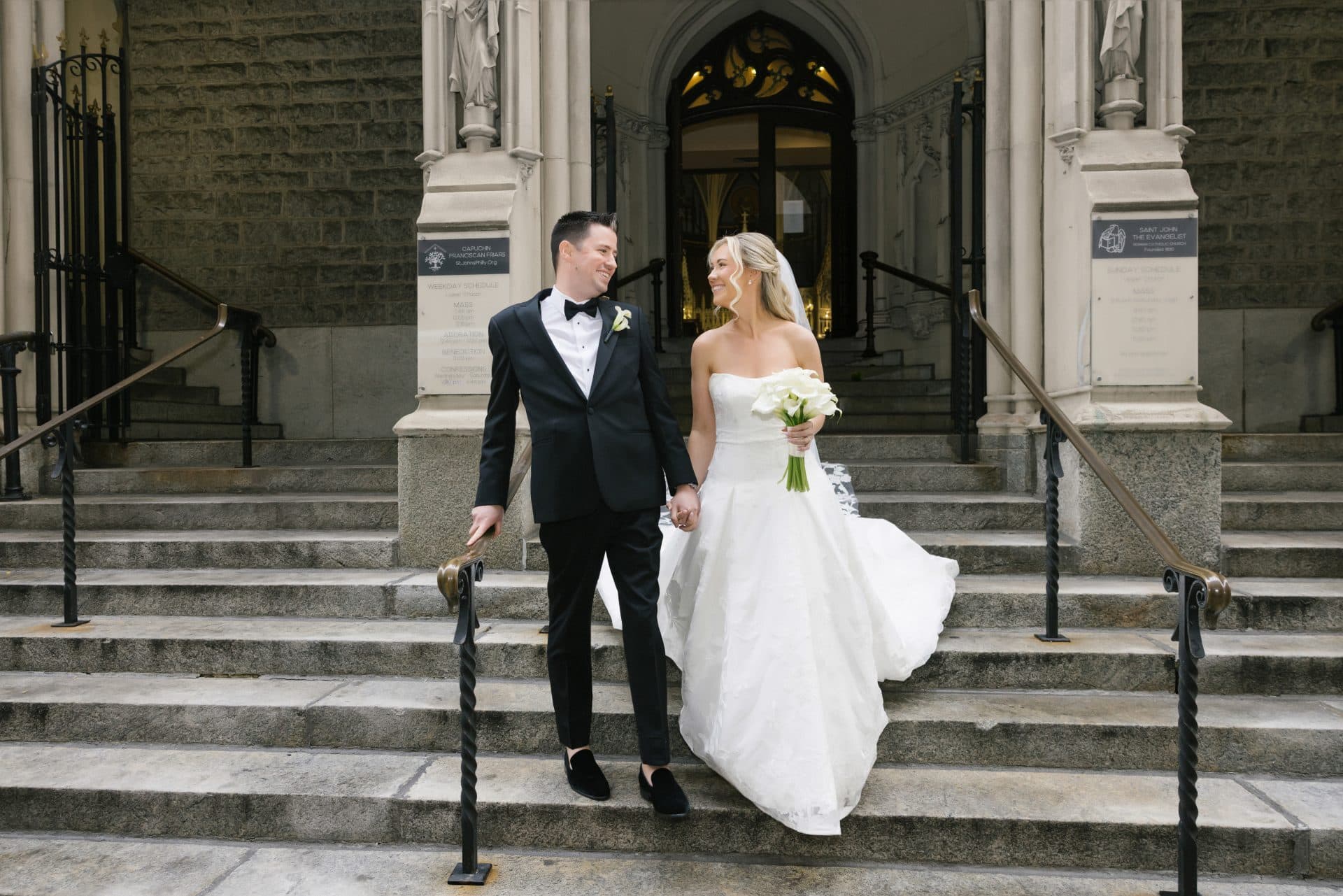 Bride and groom on church steps after ceremony at St John the Evangelist Philadelphia