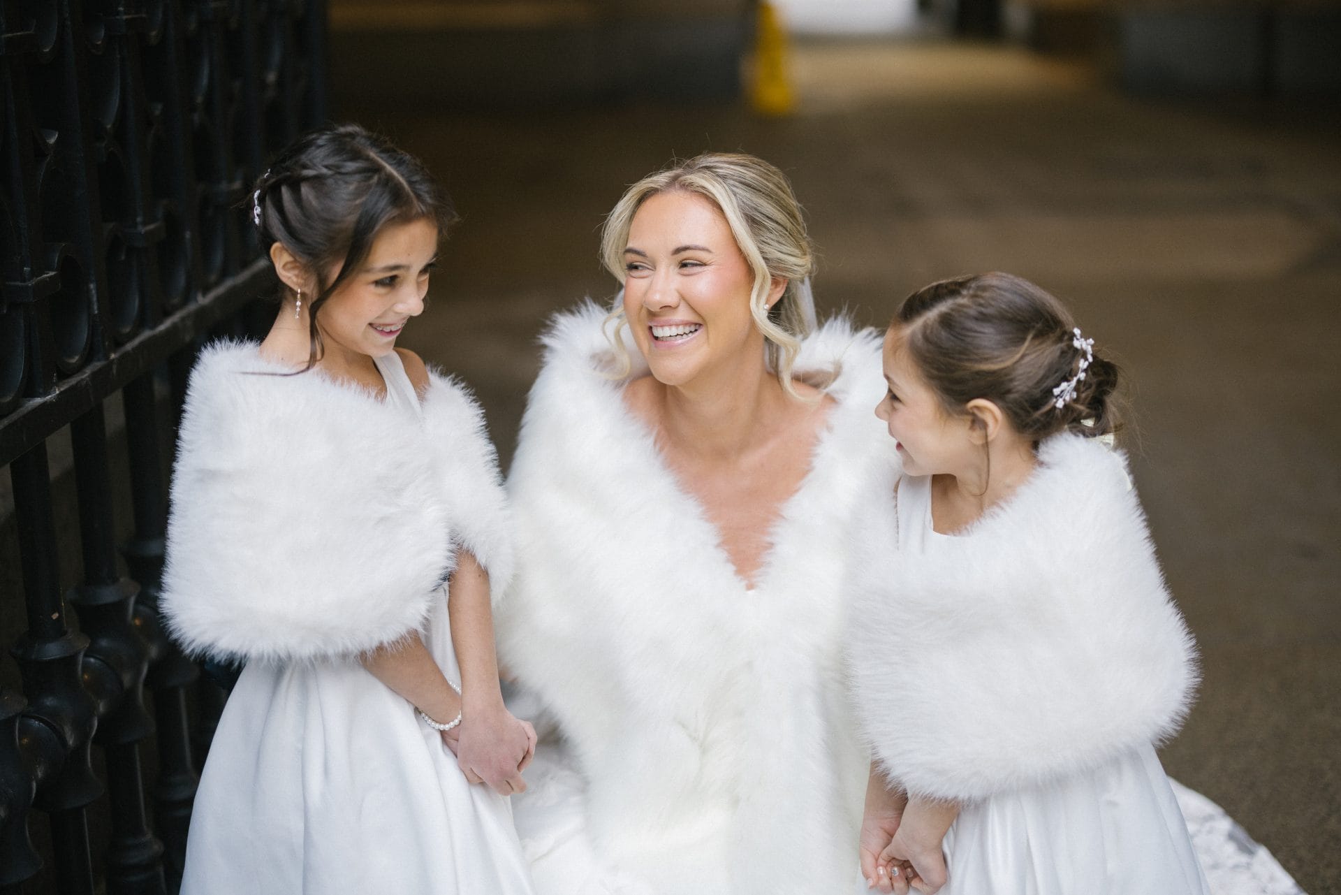 Bride with flower girls in white fur wraps at Philadelphia City Hall