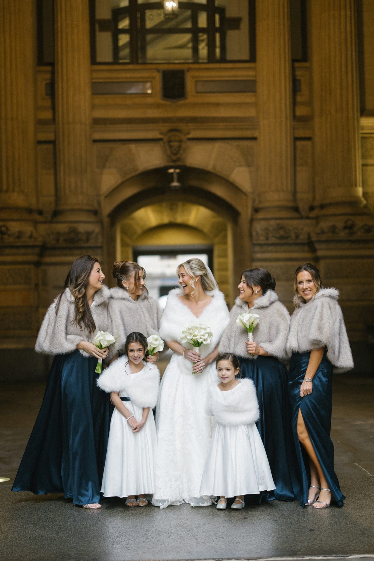 Bridal party candid laughing moment at Philadelphia City Hall archway