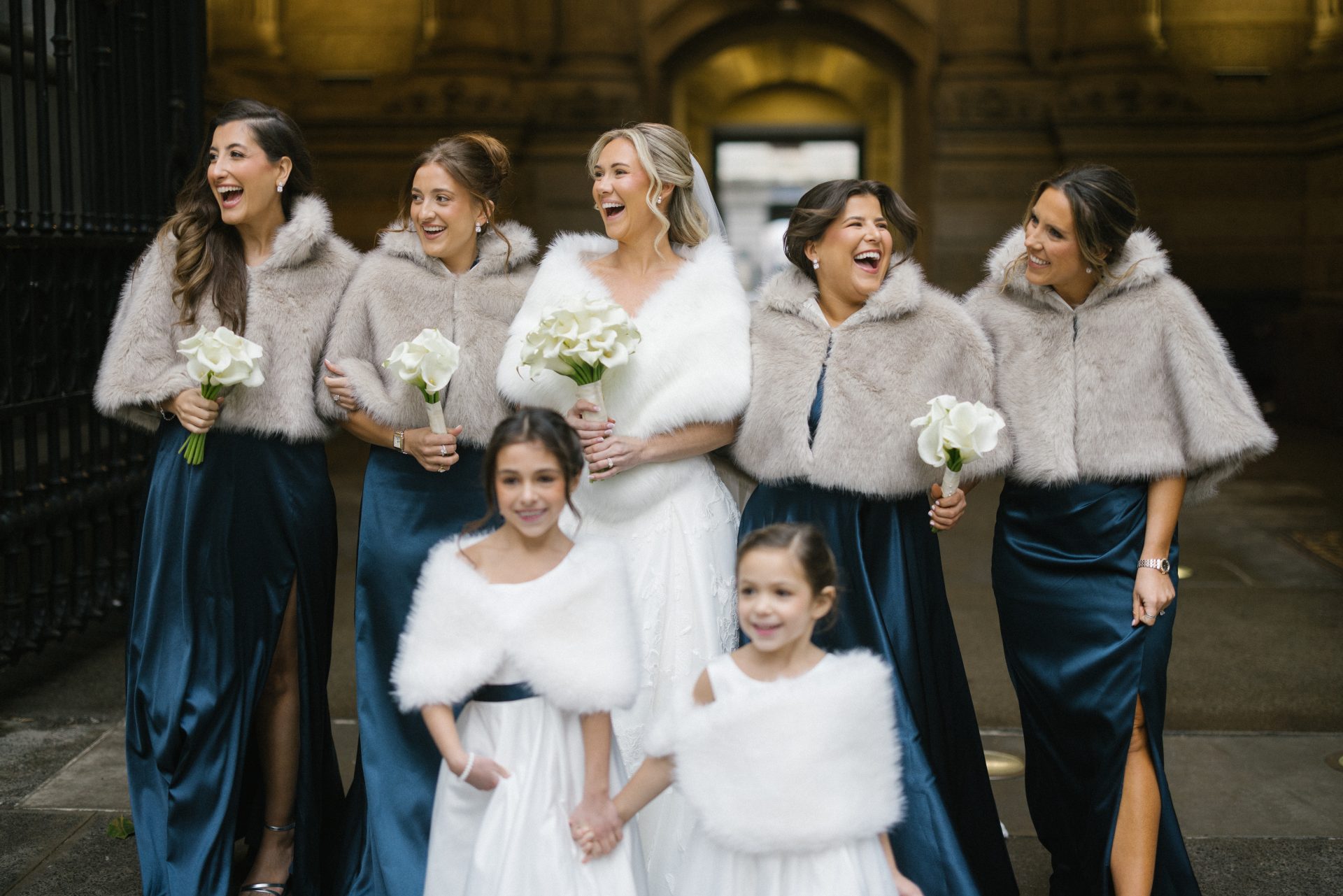Bridesmaids and flower girls in fur wraps at Philadelphia City Hall wedding portraits