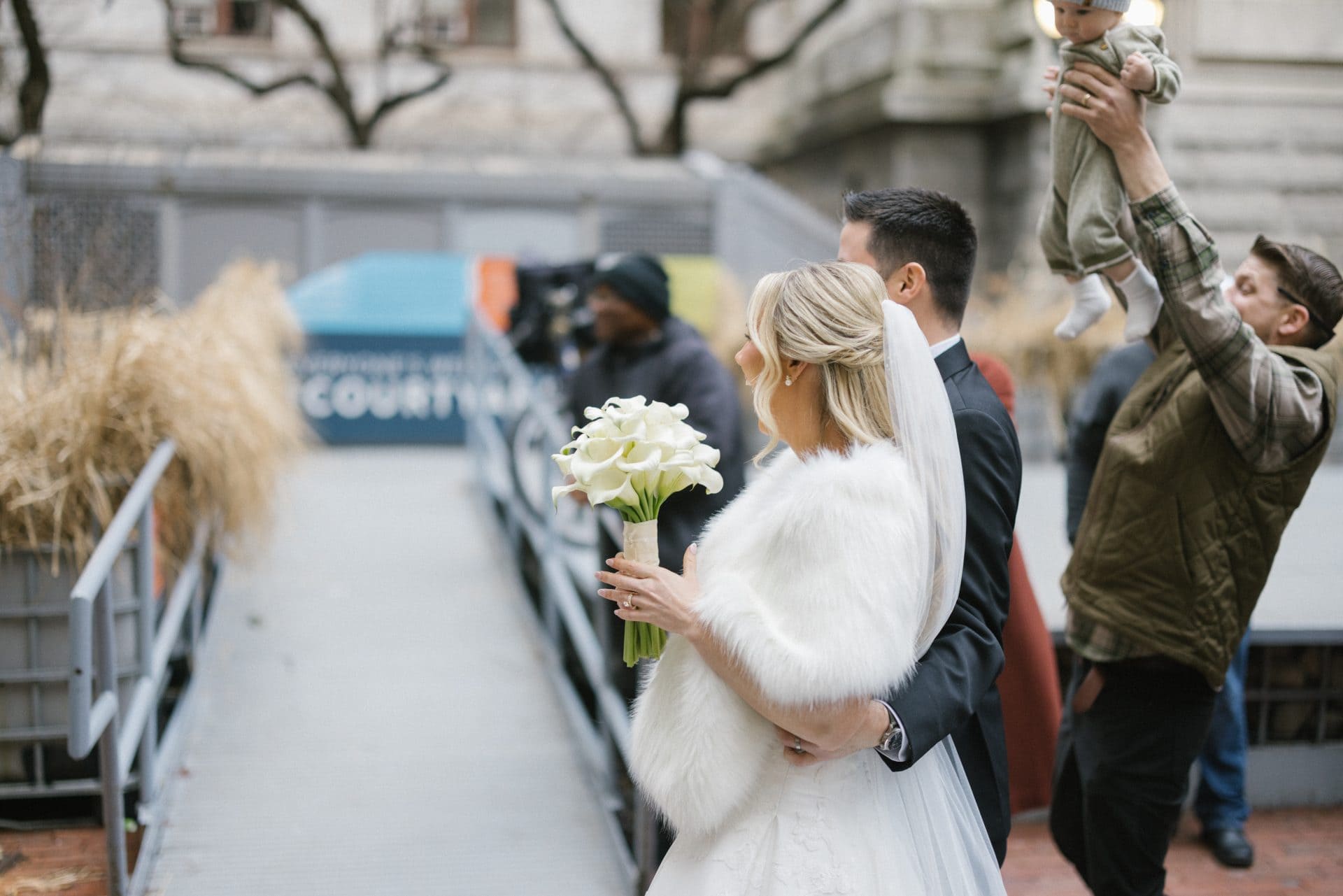 Couple kissing at Philadelphia City Hall courtyard on wedding day