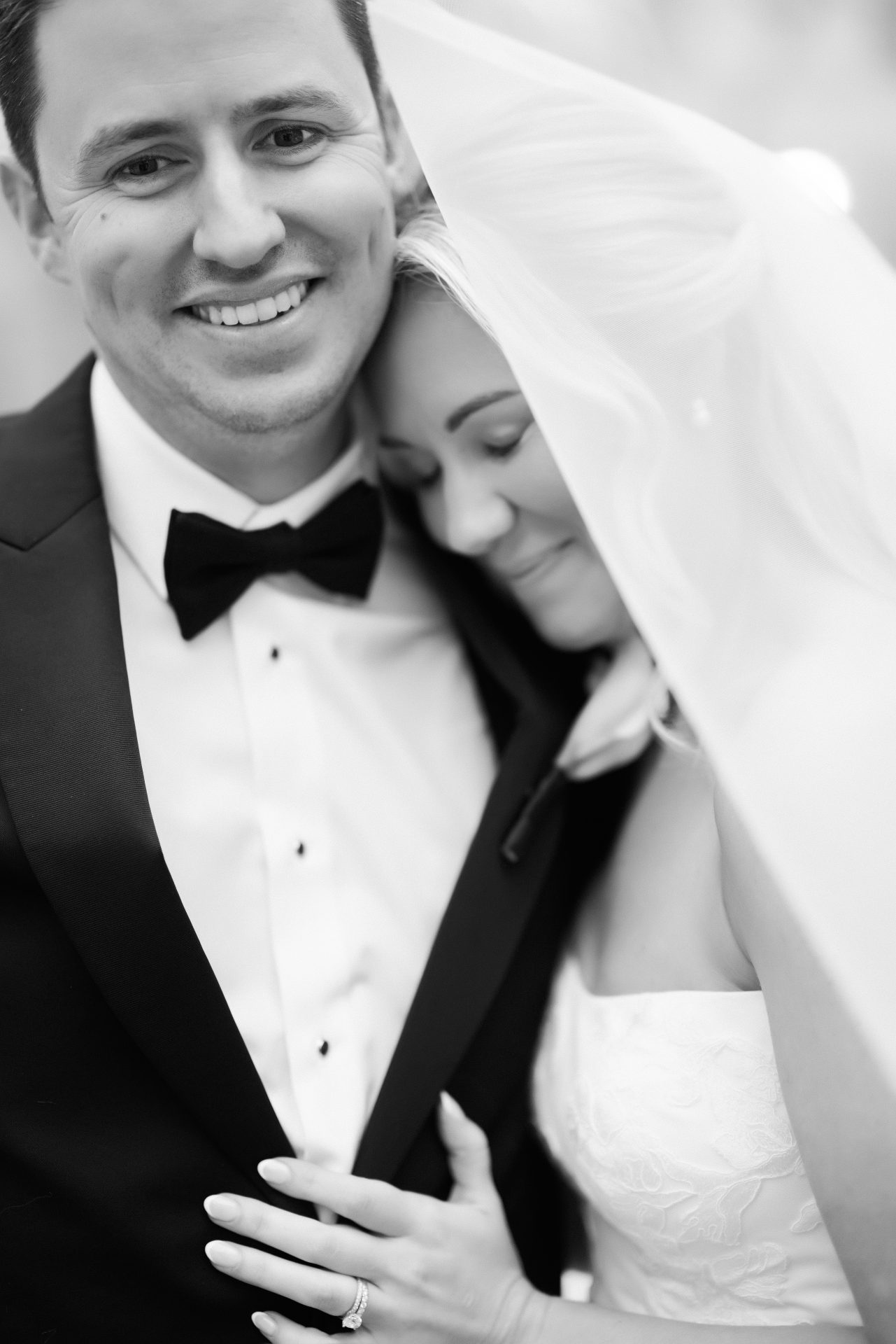 Close up groom smiling with bride under veil Philadelphia wedding portraits