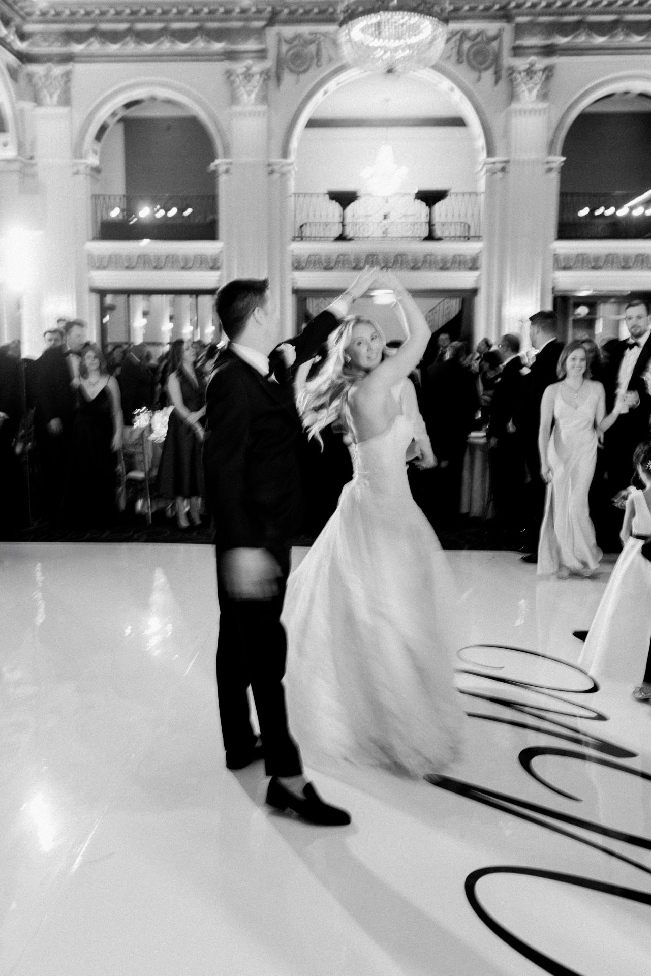 Groom spinning bride during first dance at Ballroom at the Ben custom dance floor