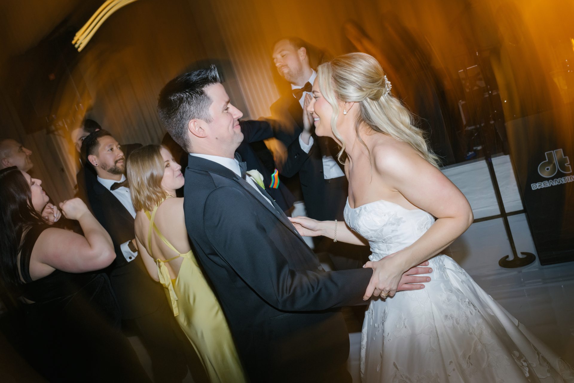 Couple dancing together on dance floor with live band at Ballroom at the Ben