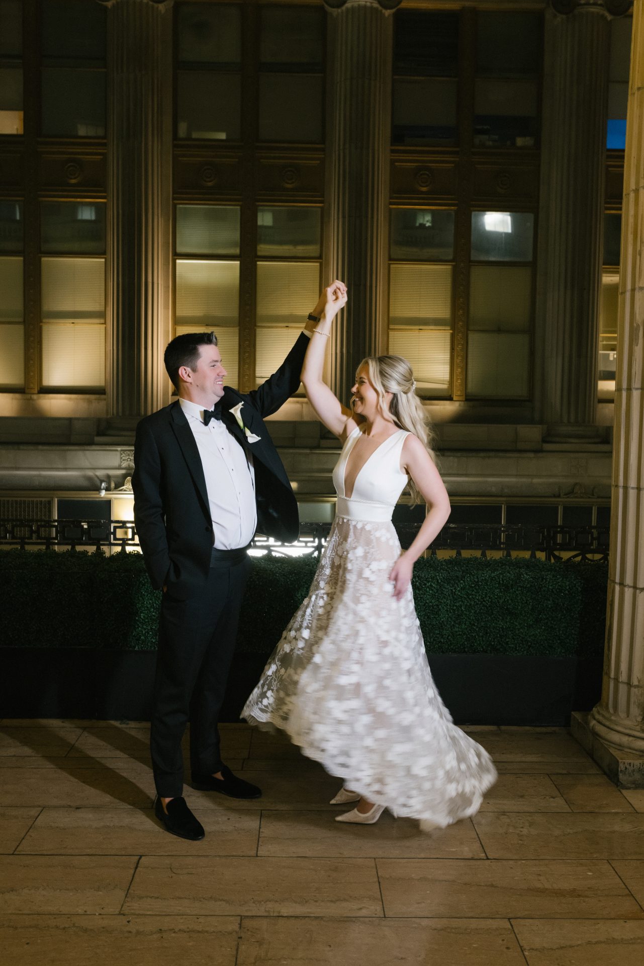 Groom spinning bride at night on balcony at Ballroom at the Ben Philadelphia