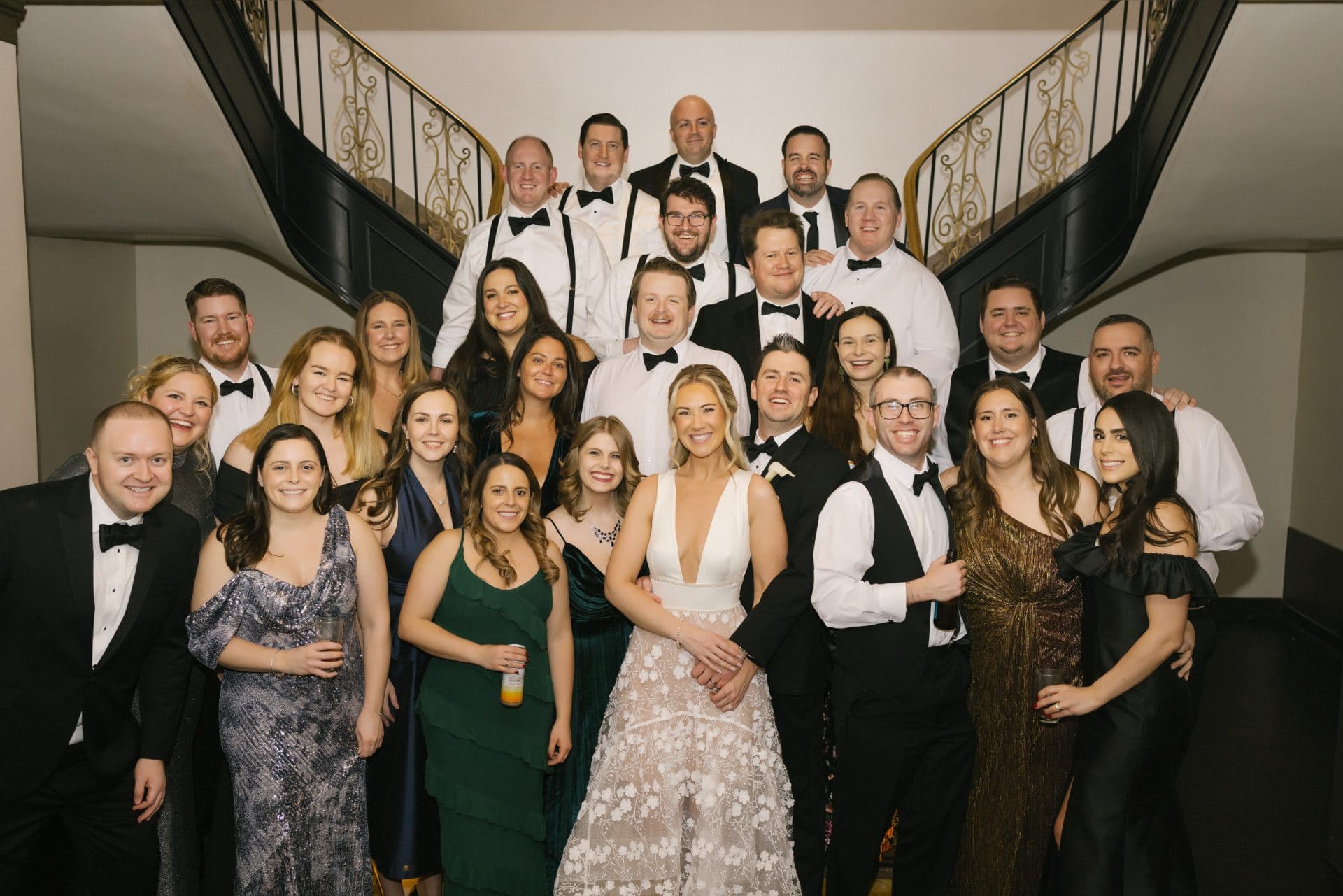 Large group photo on ballroom staircase at end of night Ballroom at the Ben wedding