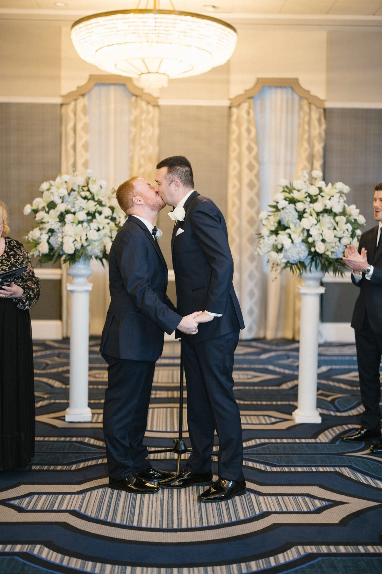 Couple's first kiss at their indoor wedding ceremony at The Notary Hotel in Philadelphia