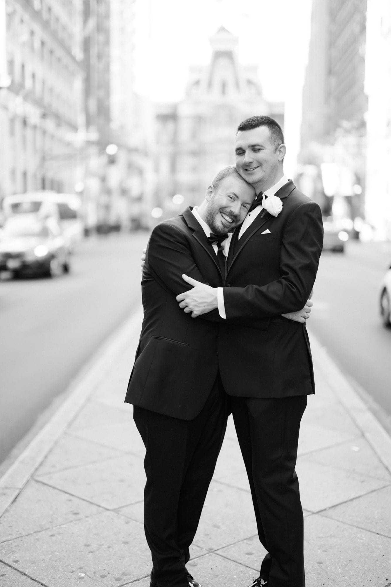 Couple embracing on the street outside Philadelphia City Hall near The Notary Hotel