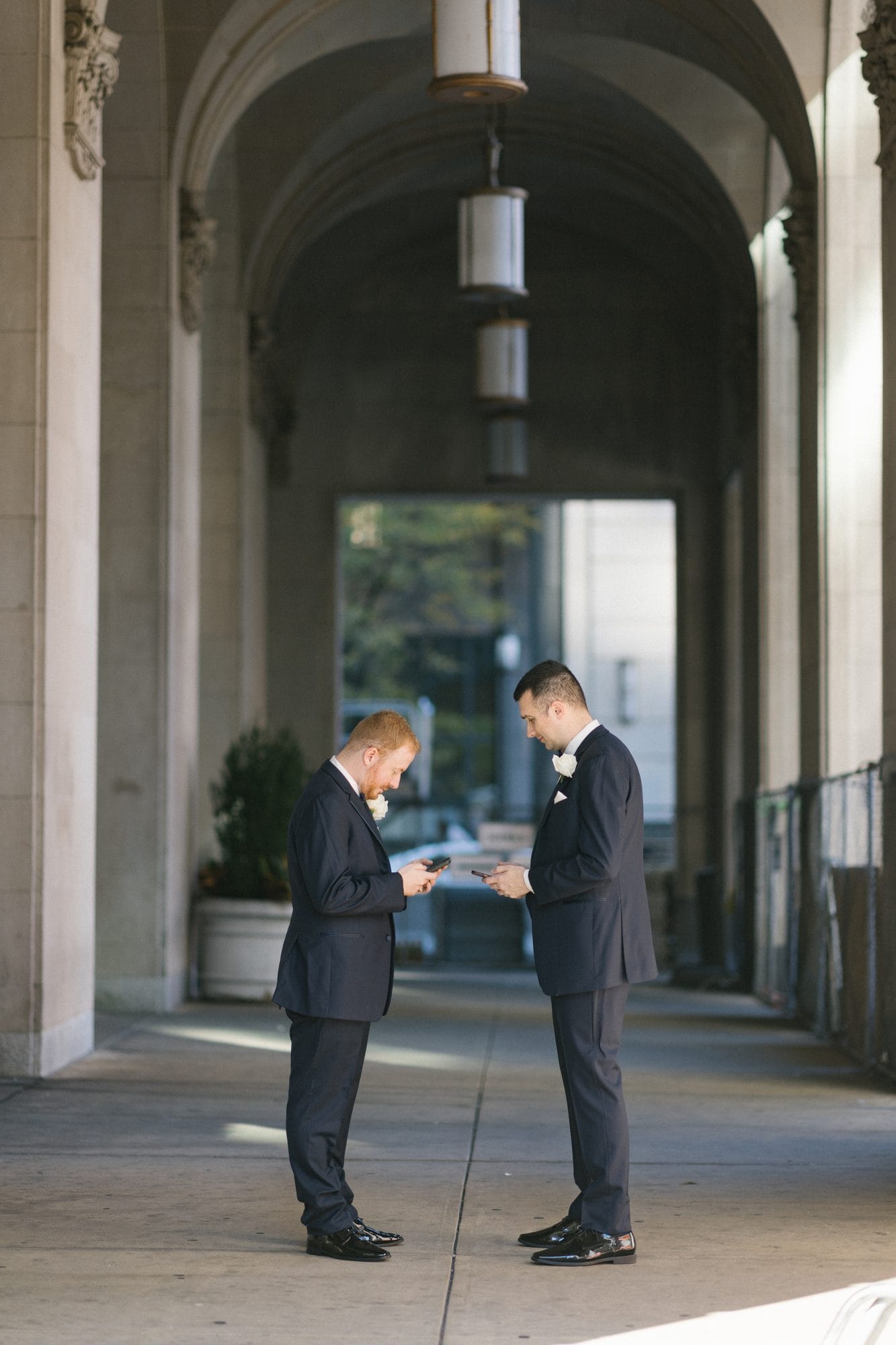 Couple photographed in the covered colonnade outside The Notary Hotel in Philadelphia