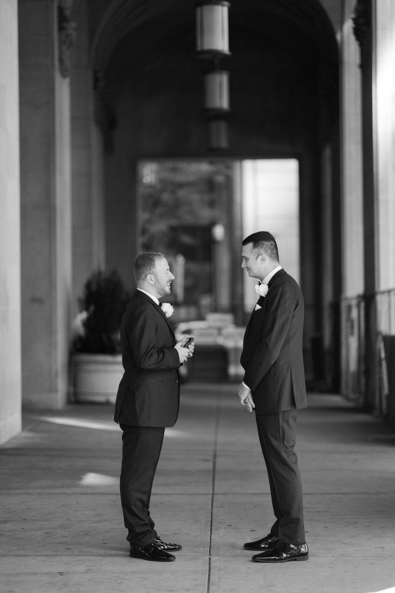 Couple photographed under the covered colonnade at The Notary Hotel, the venue's rain plan for portraits